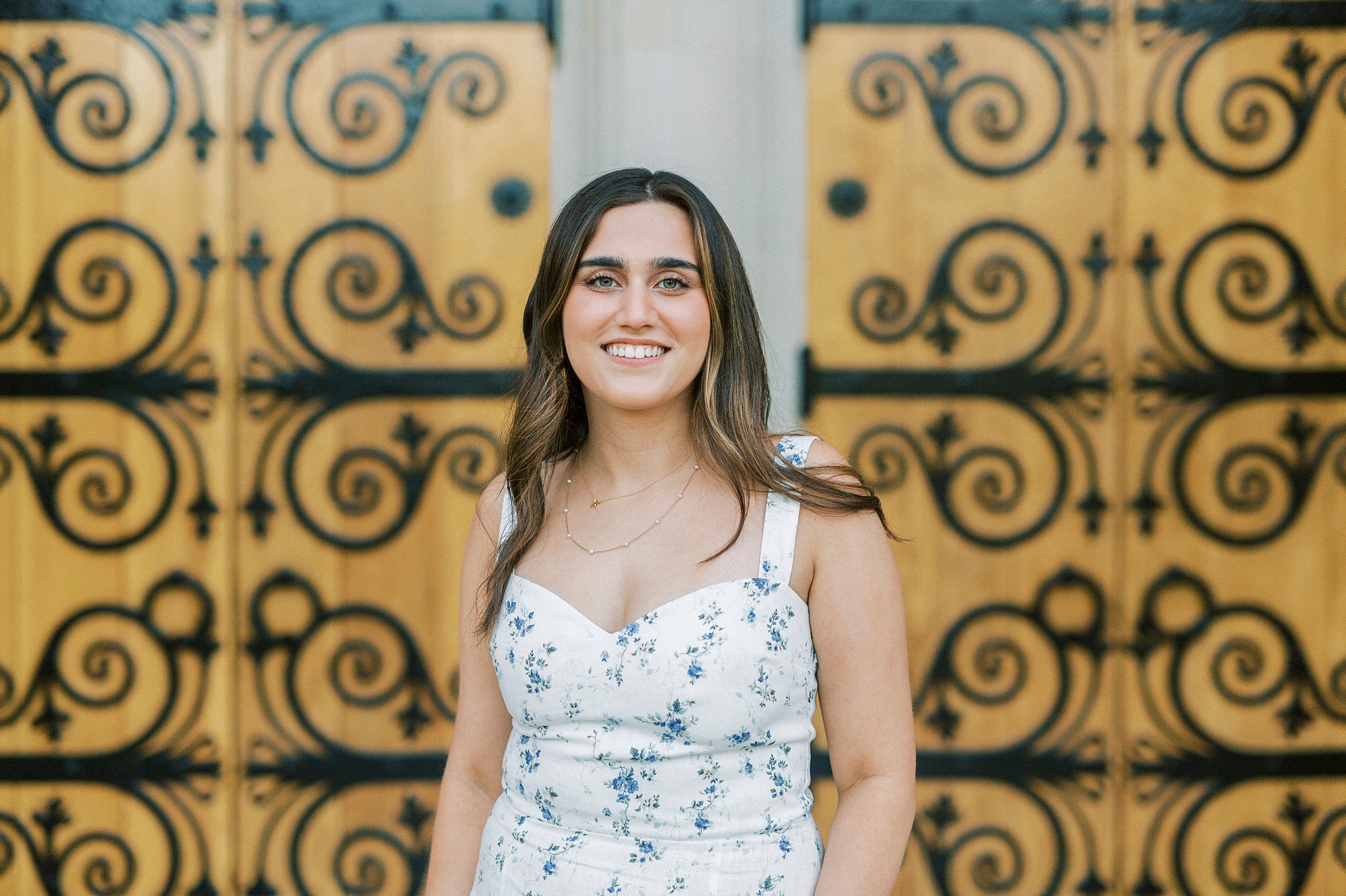 senior poses by chapel doors on Duke's campus