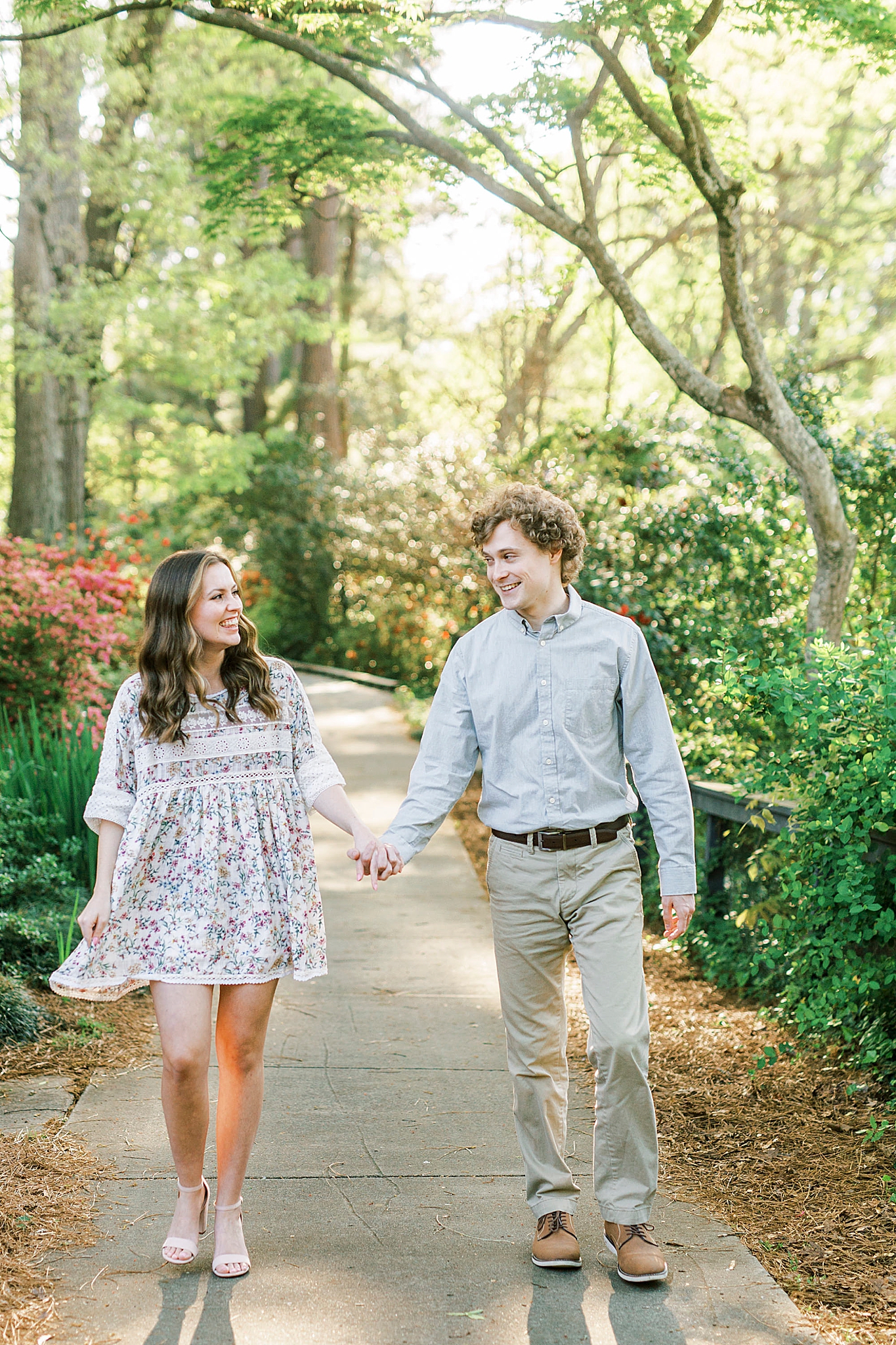 couple walks through Glencairn Gardens in Rock Hill SC