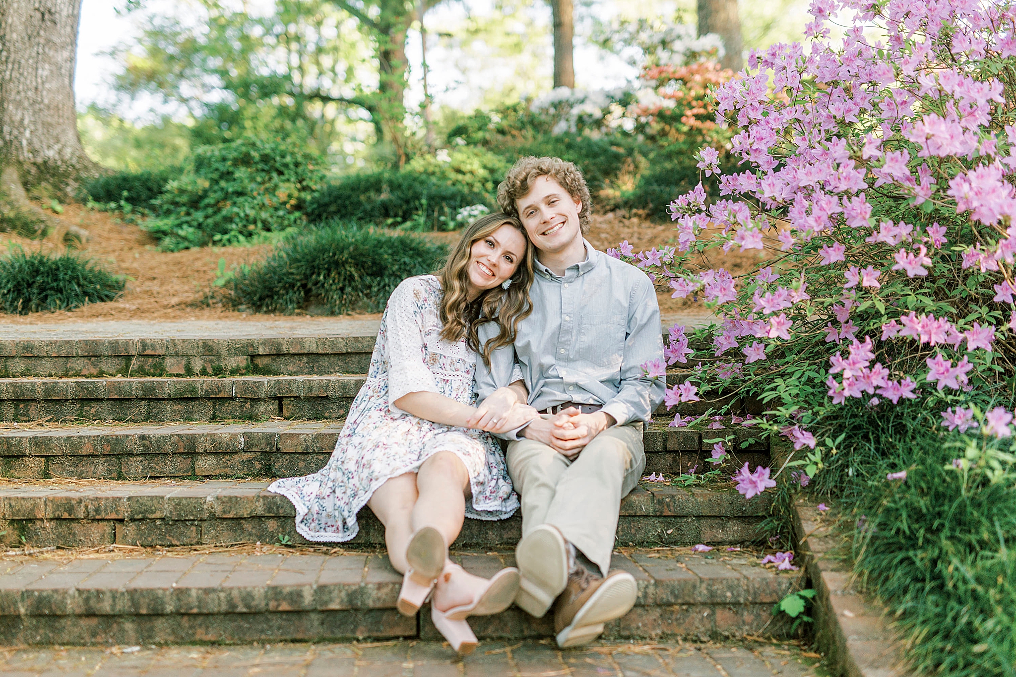 bride and groom sit on steps in Glencairn Gardens