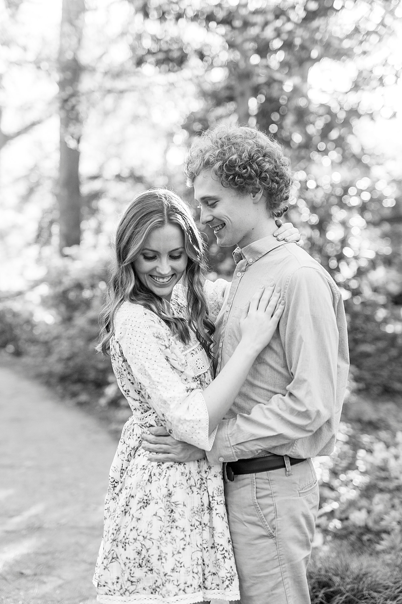 groom looks down at bride during Glencairn Gardens engagement photos