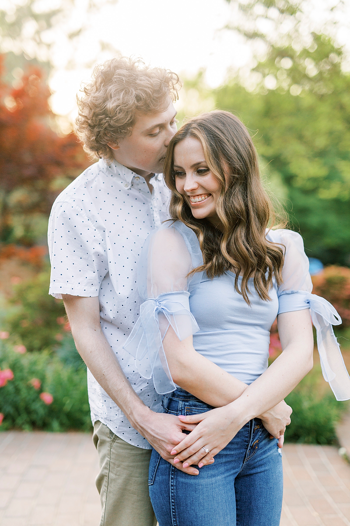 groom hugs bride during Glencairn Gardens engagement photos