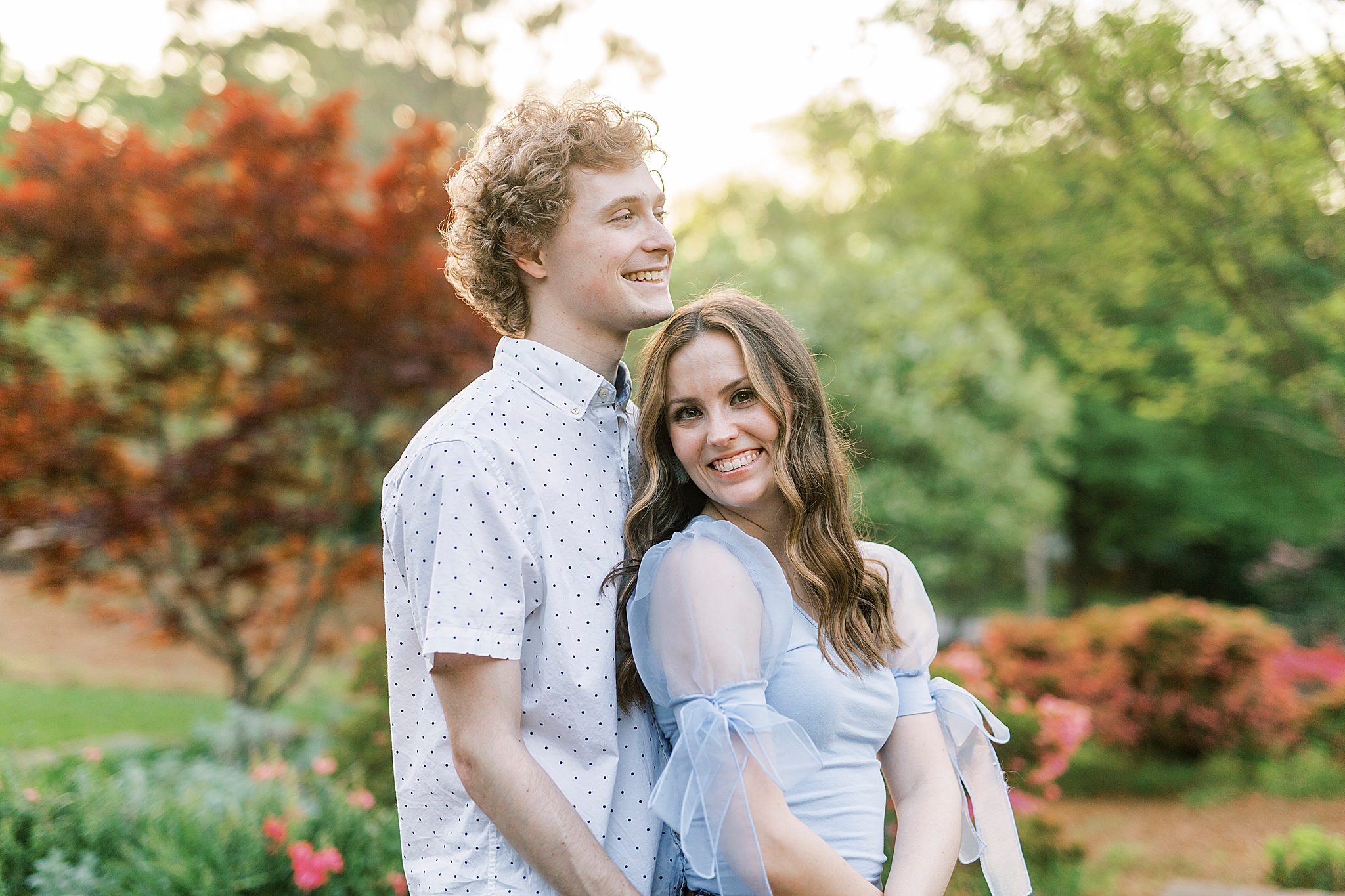 couple hugs during springtime engagement photos