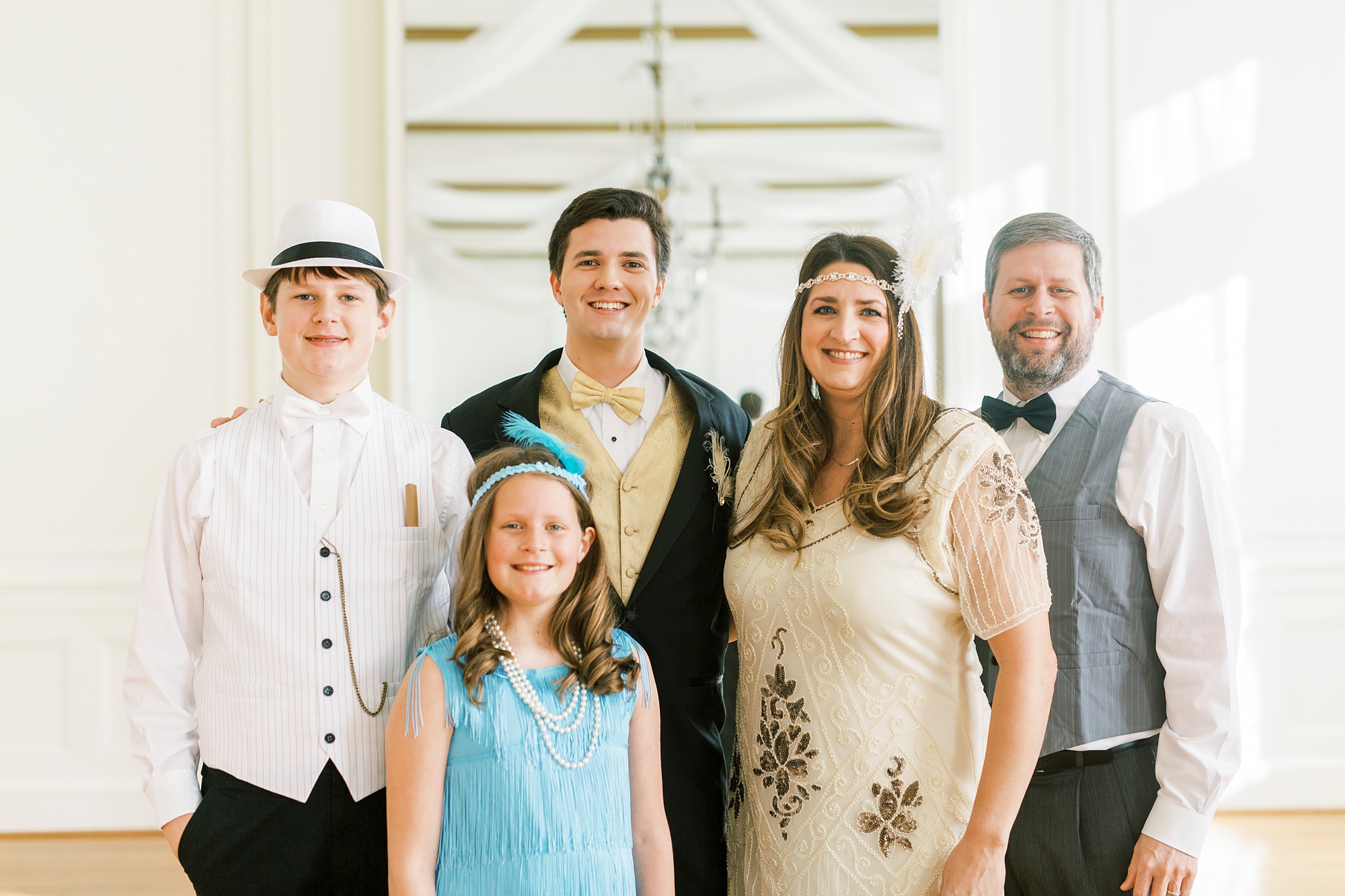 family in Great Gatsby attire poses together during roaring 20's birthday party