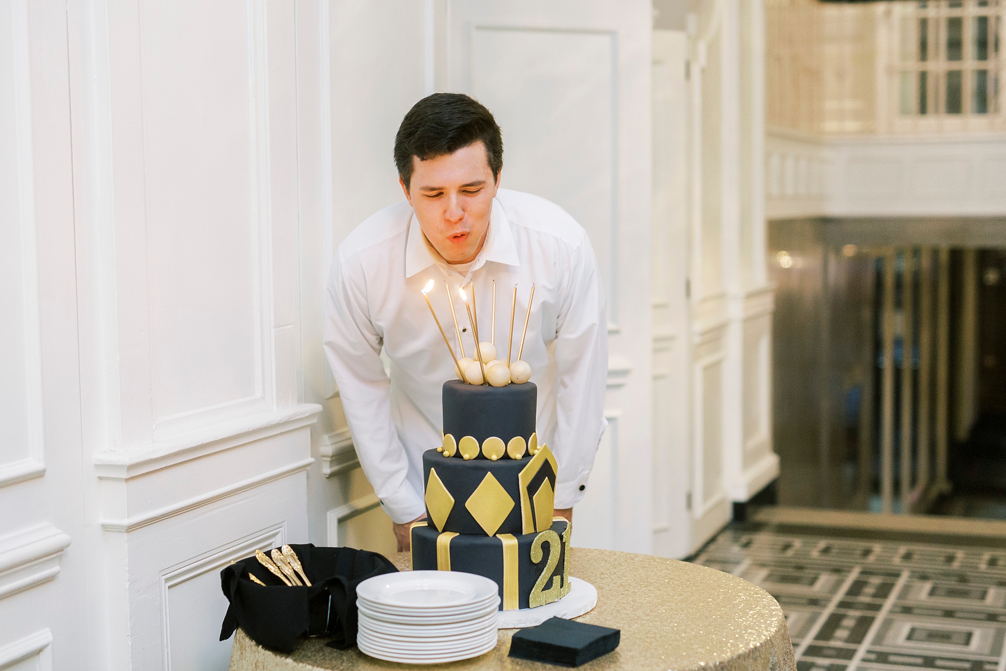 21 year old blows out birthday candles during themed birthday party