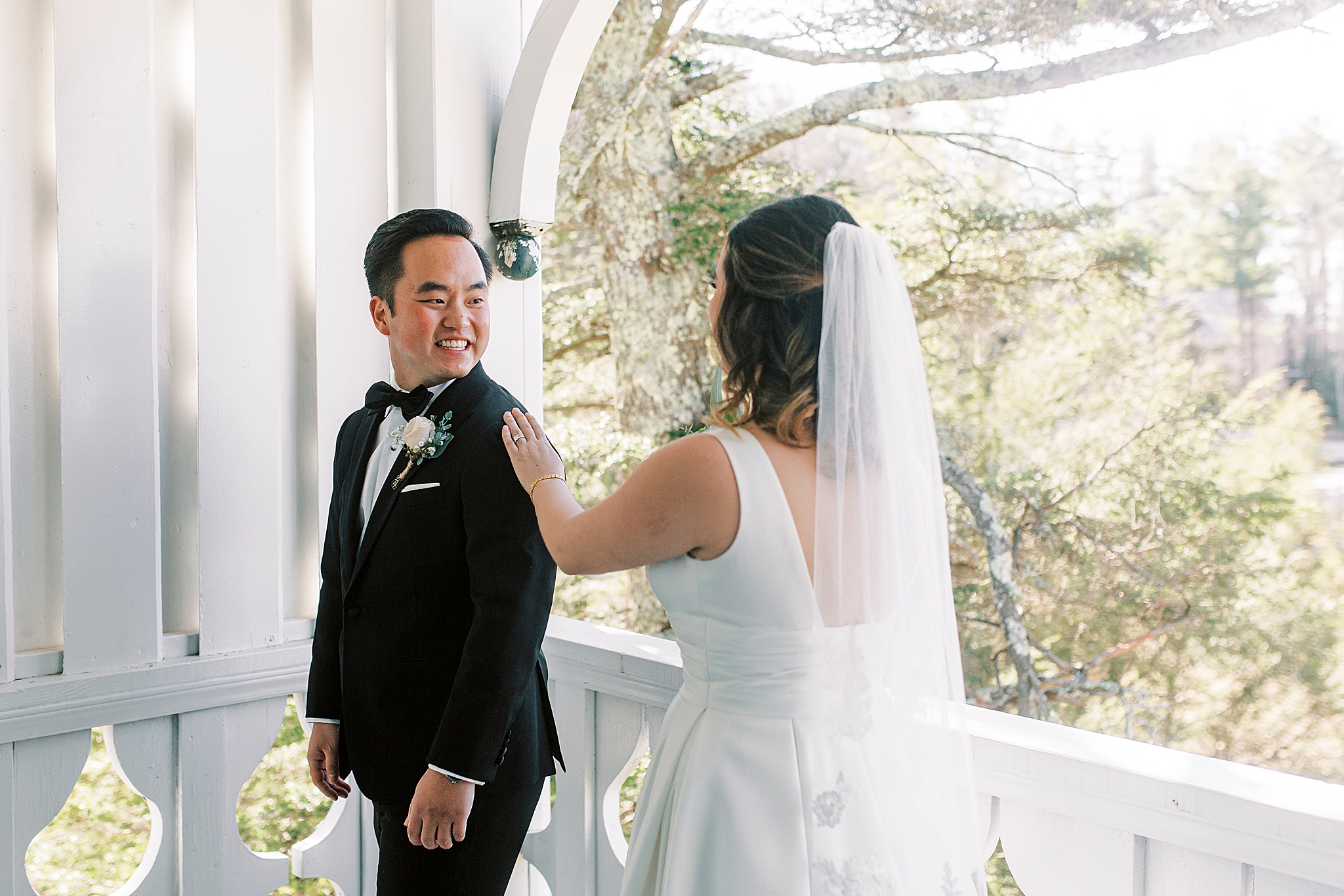bride taps groom's shoulder during first look