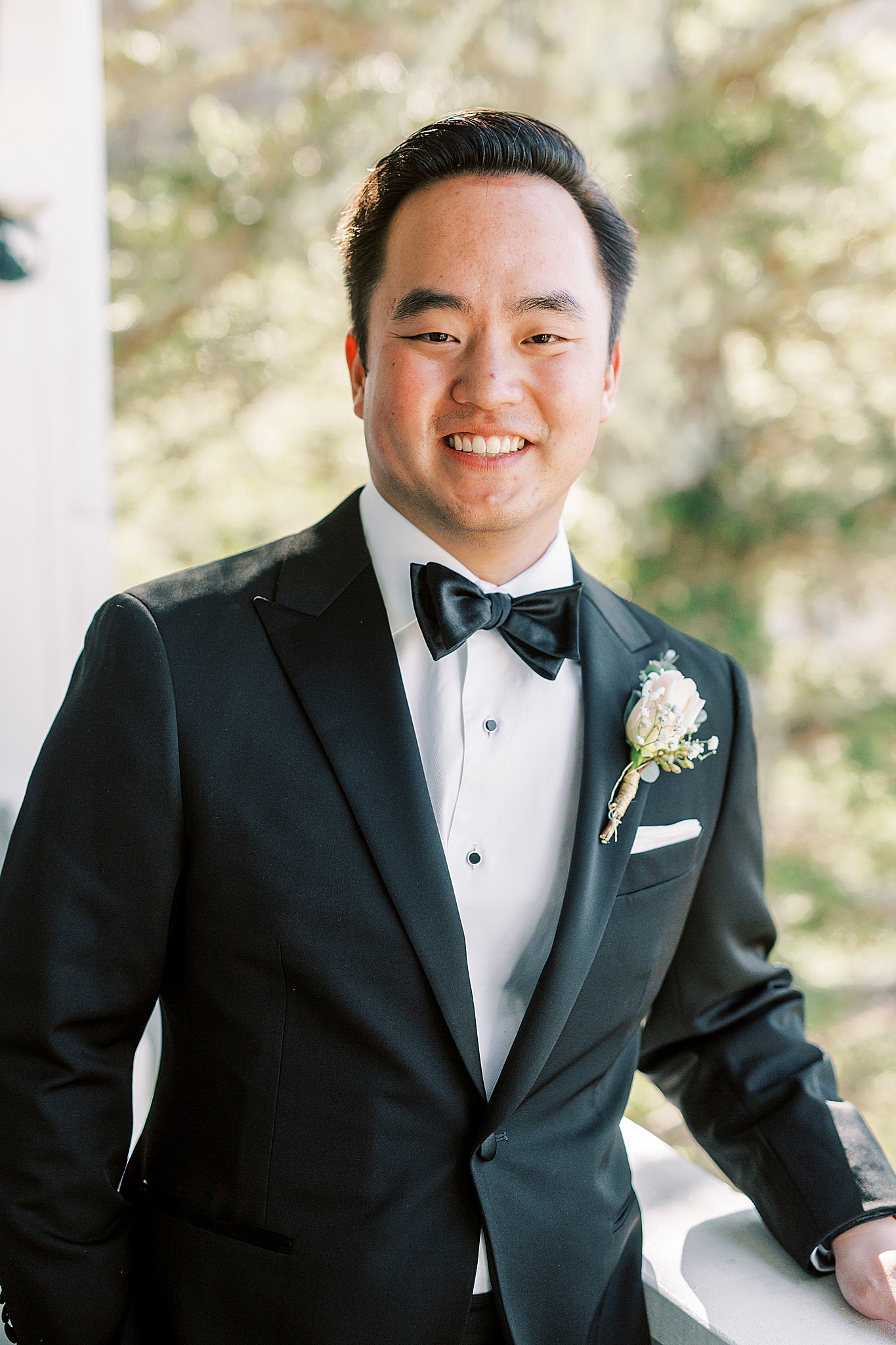 classic attire for groom on balcony