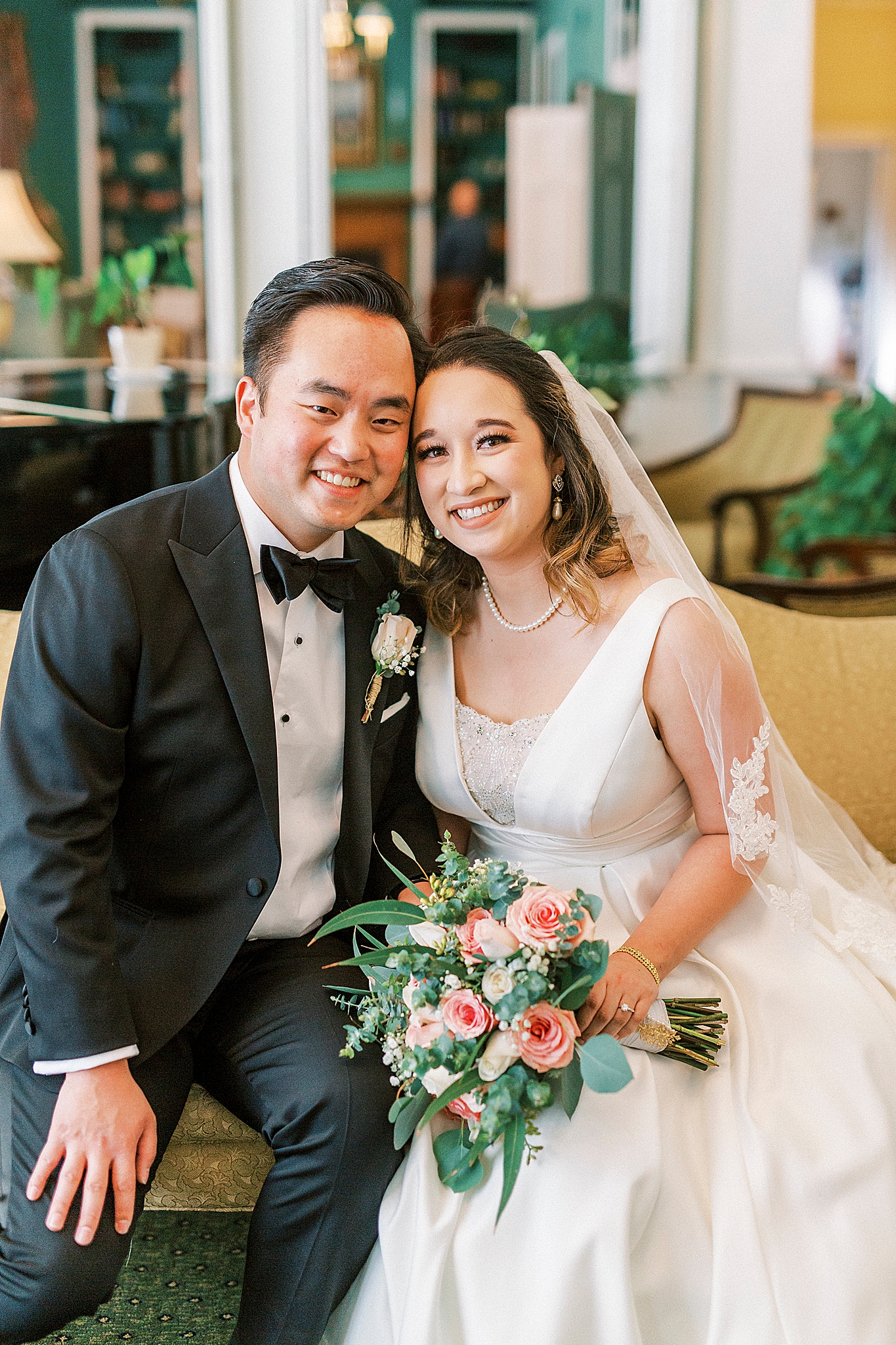 bride and groom lean in together on couch