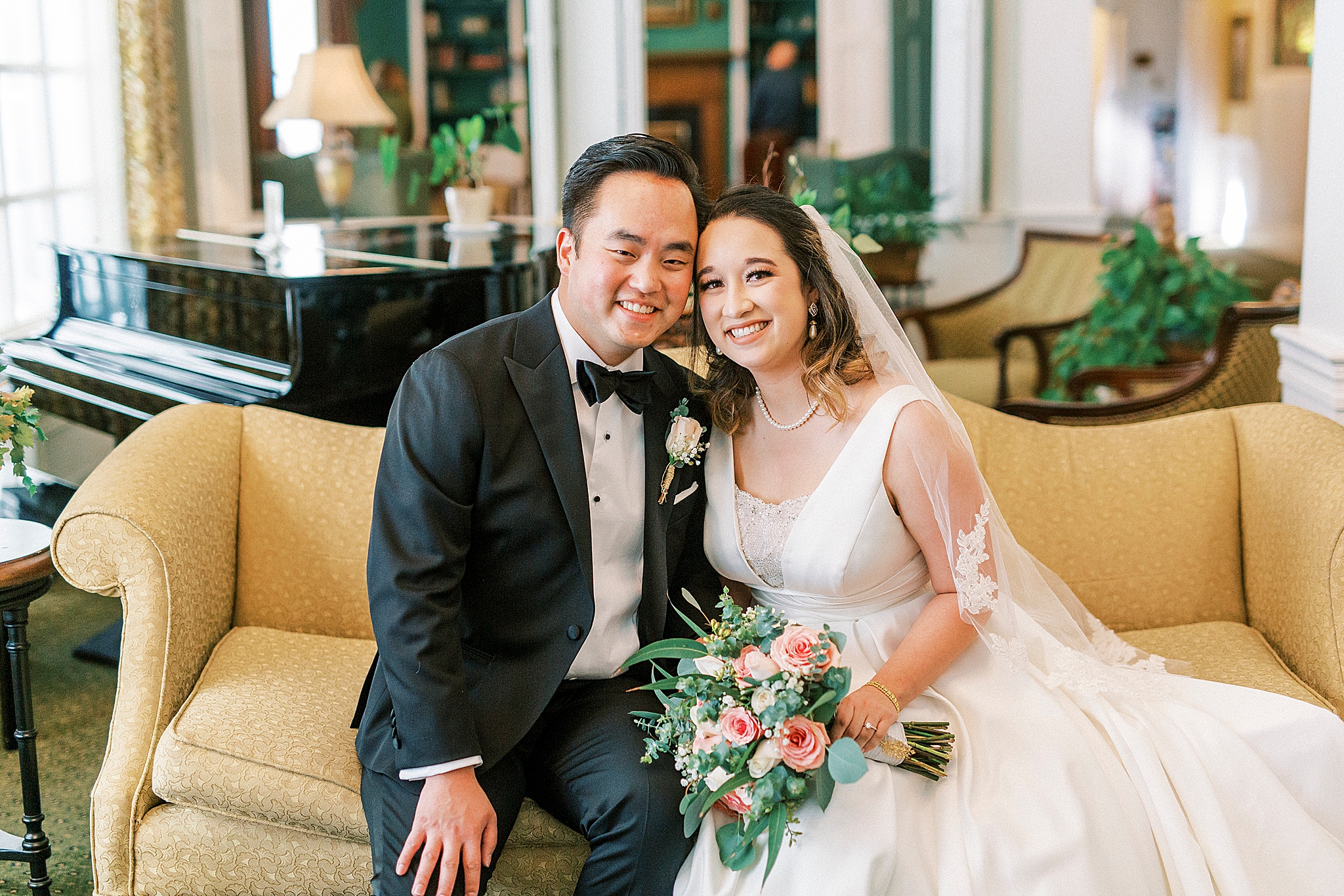 newlyweds sit on couch in study at Green Park Inn