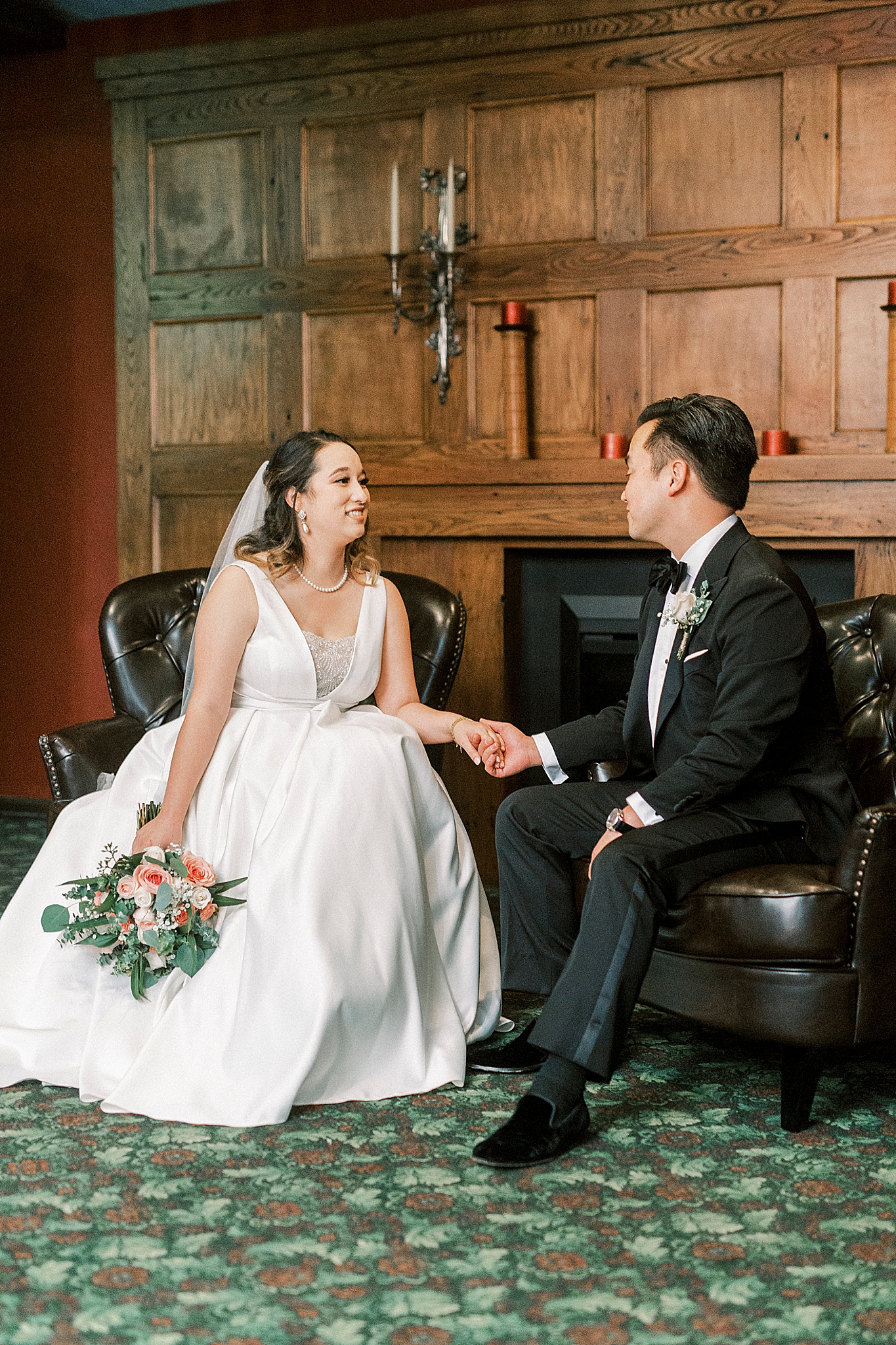 bride and groom hold hands talking on wedding day