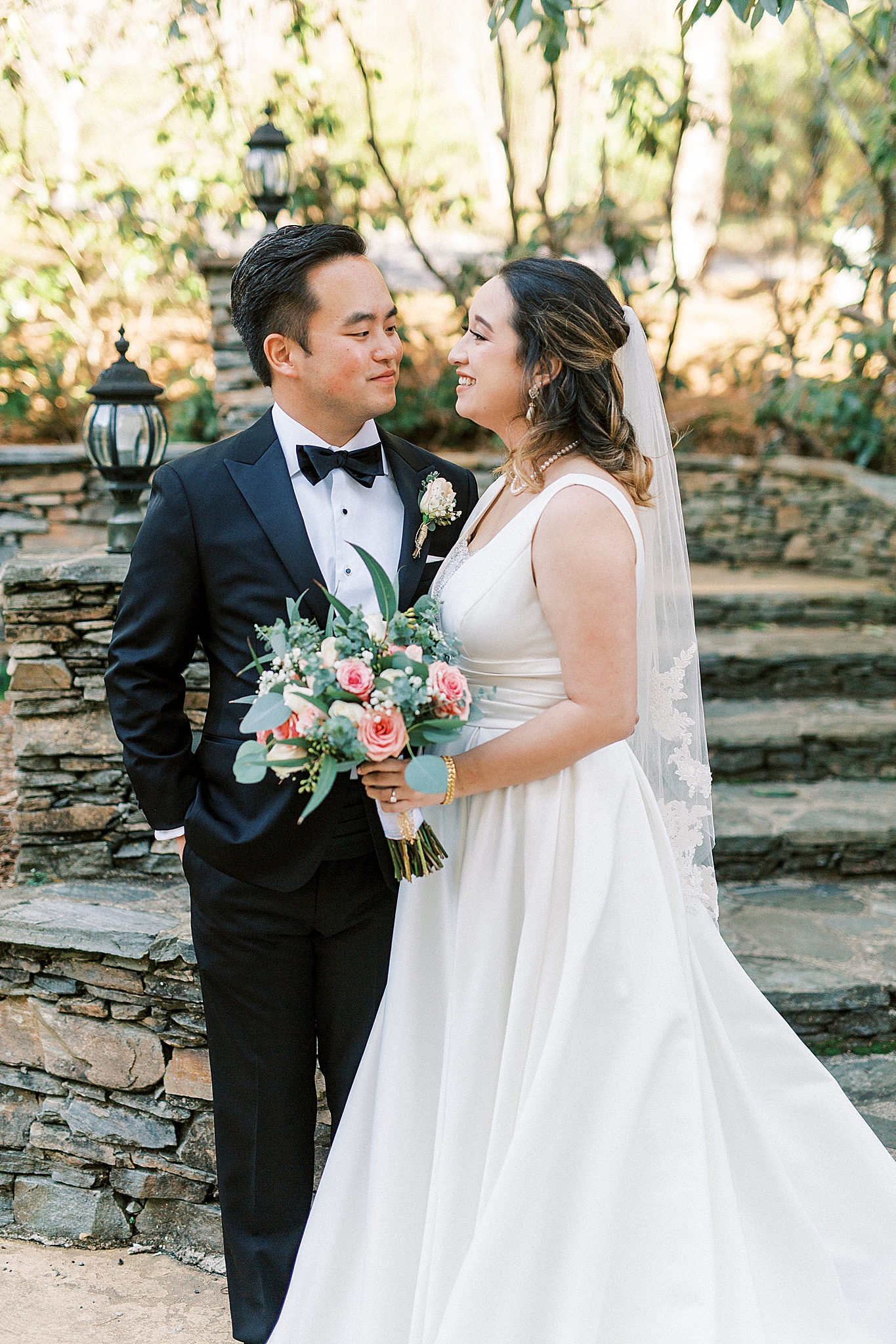 bride and groom pose by stone steps at Green Park Inn