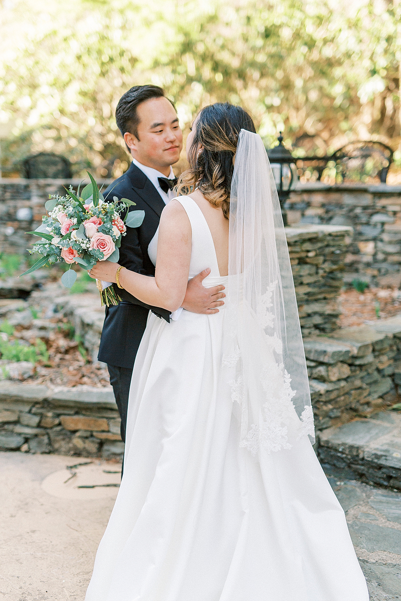 groom hugs bride by steps at Green Park Inn