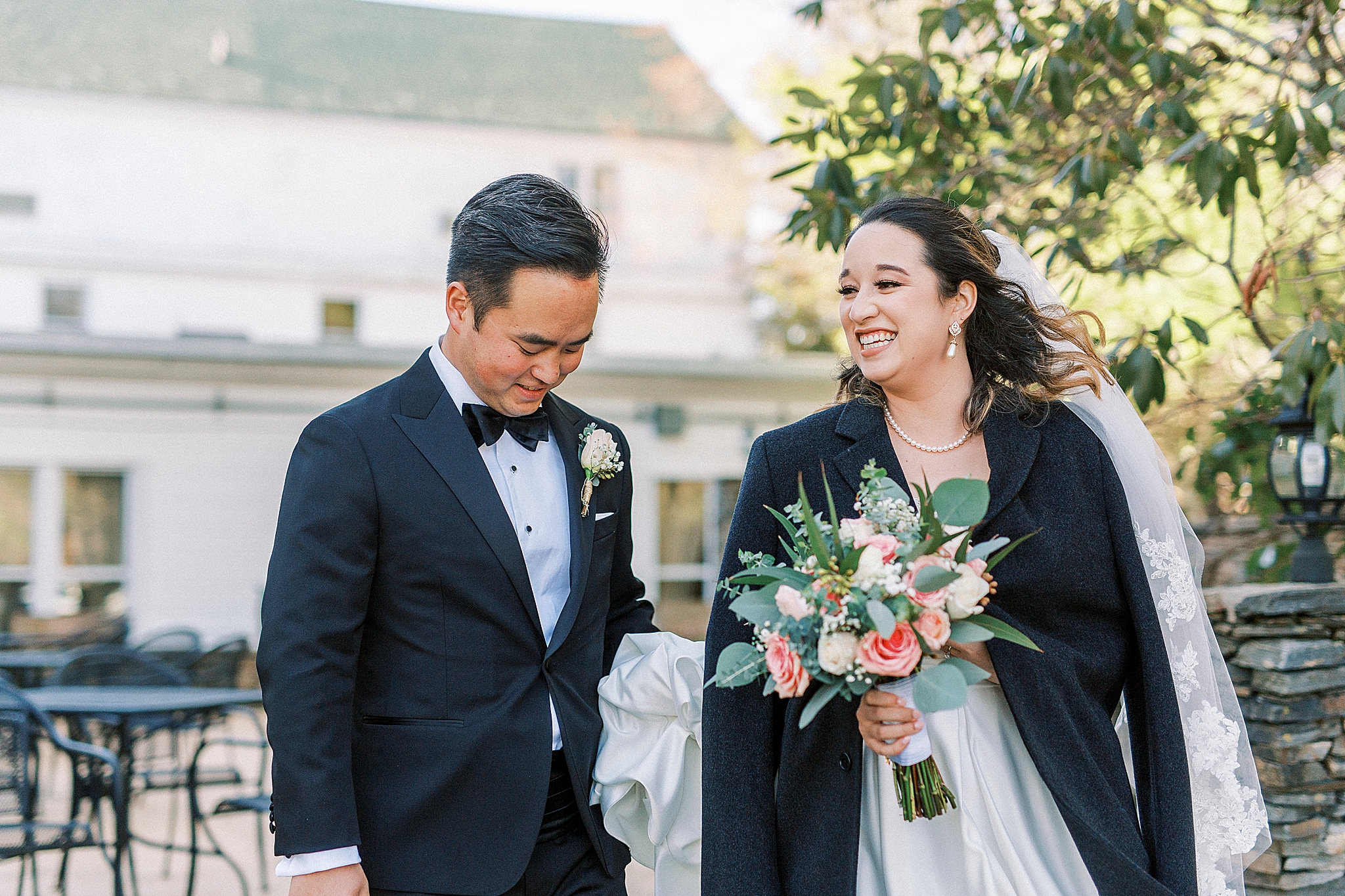 bride wears jacket during wedding portraits outside at Green Park Inn