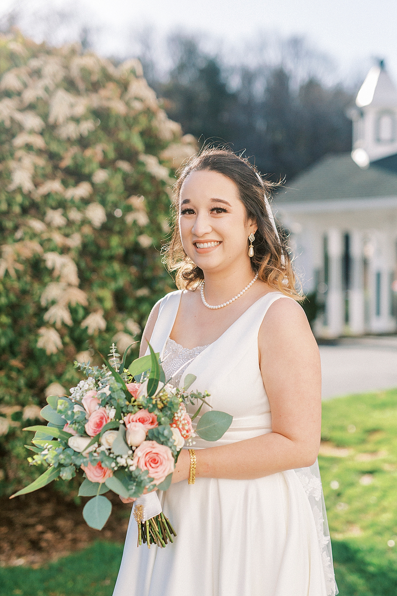 classic bridal portrait with bride holding bouquet of pink flowers