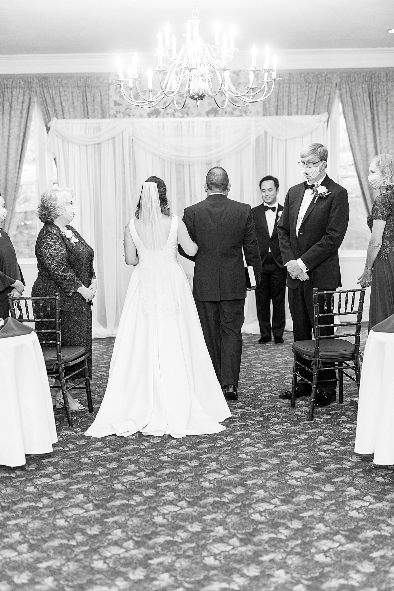 father of the bride walks bride down during ceremony
