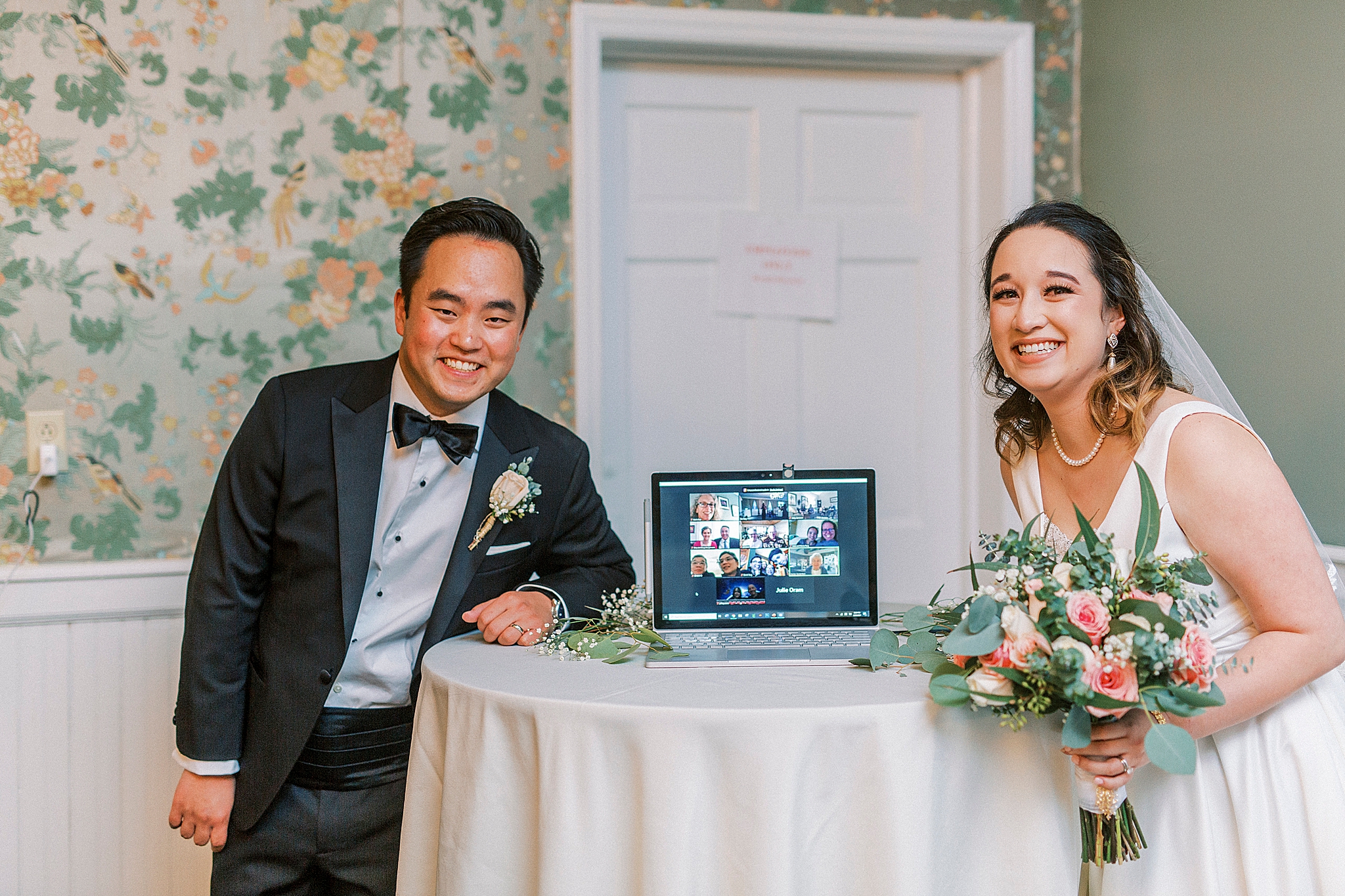 bride and groom pose with Zoom guests
