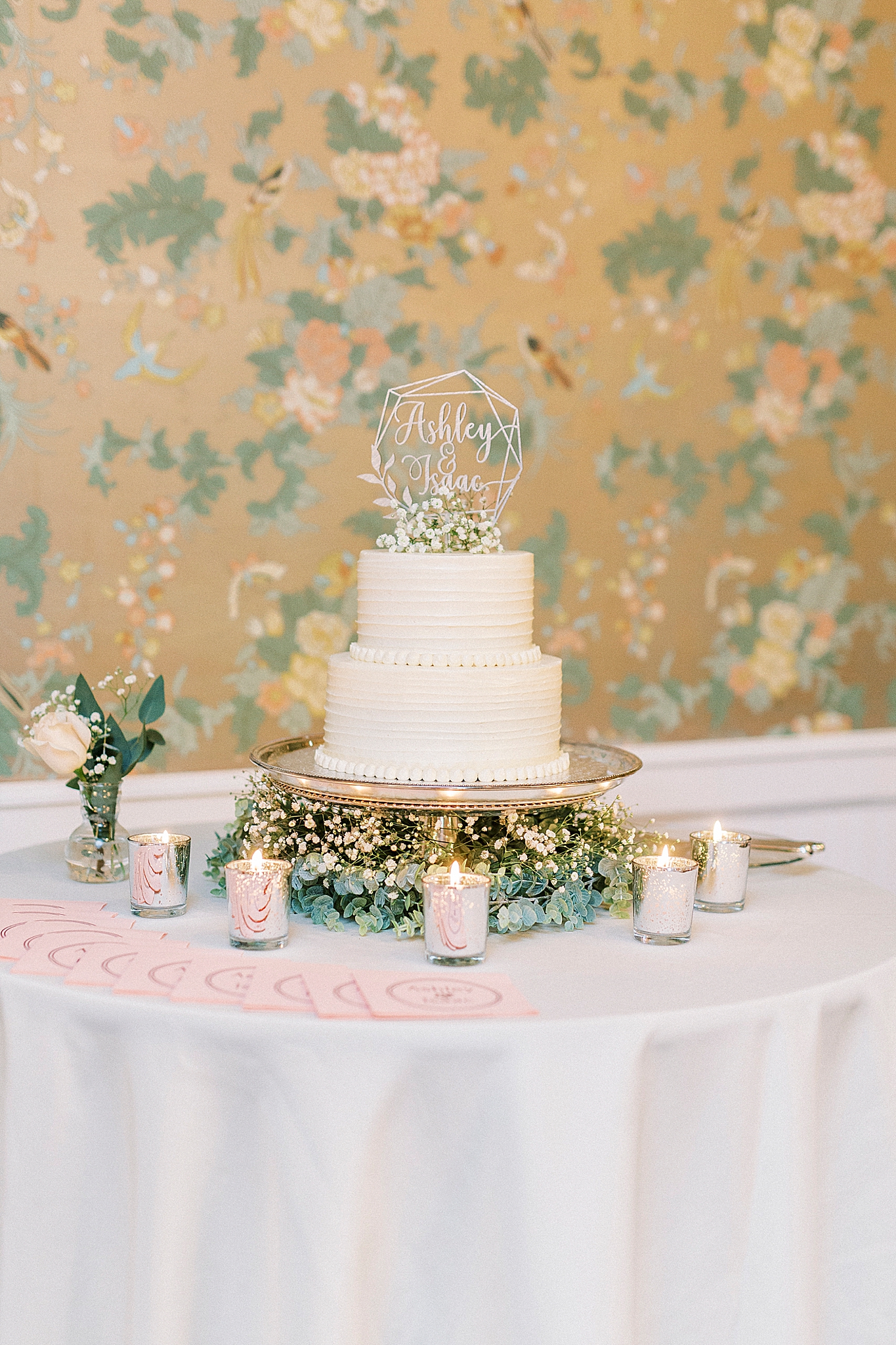 two-tiered wedding cake with topper