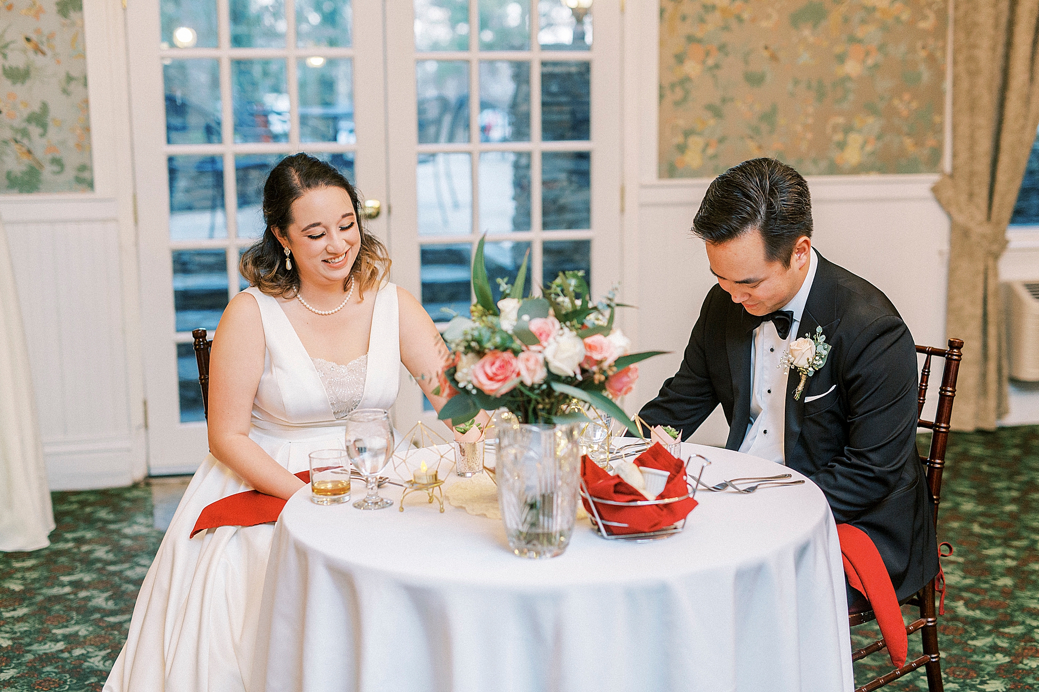 bride and groom laugh during toasts