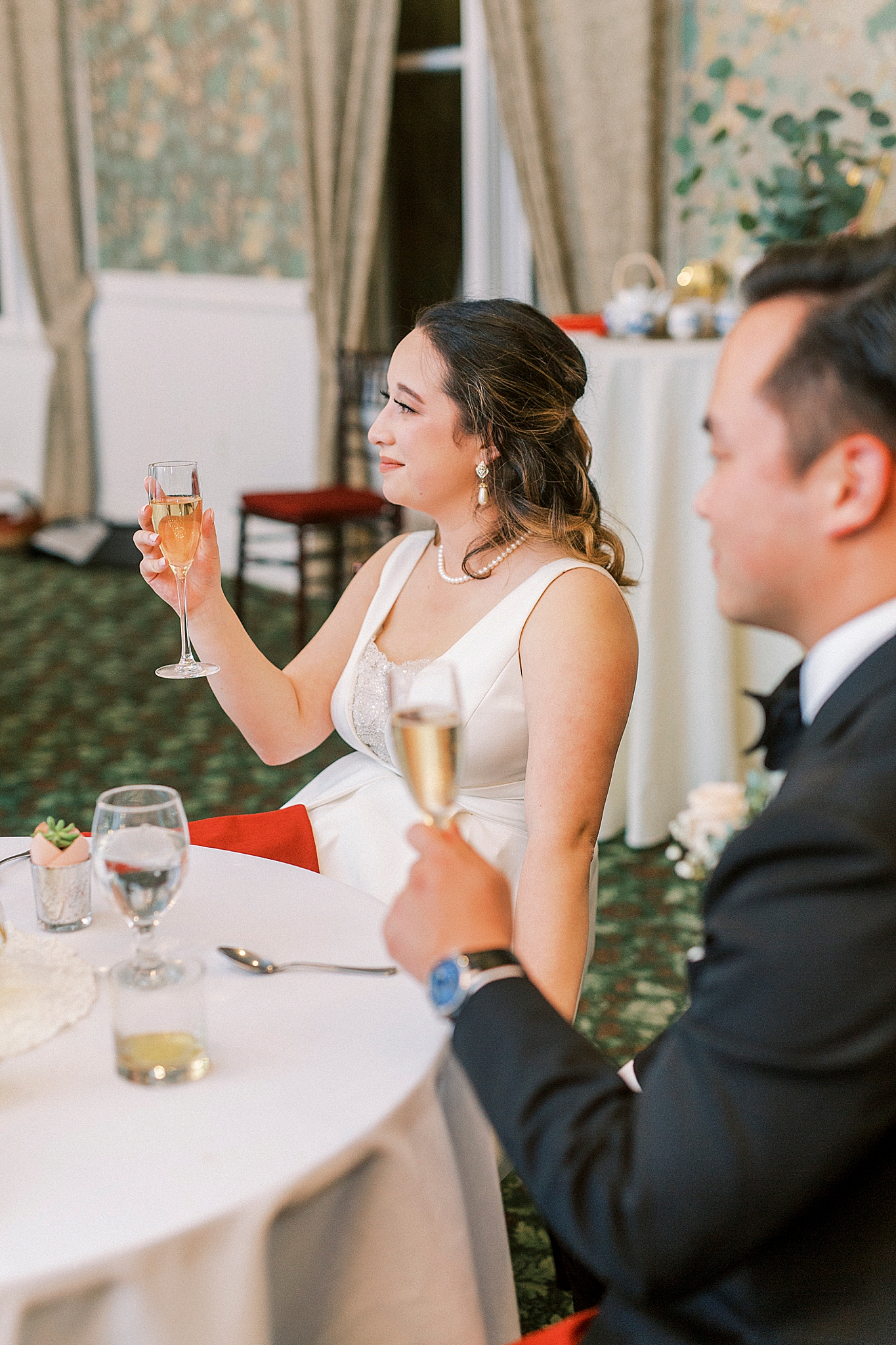 newlyweds lift champagne during toasts