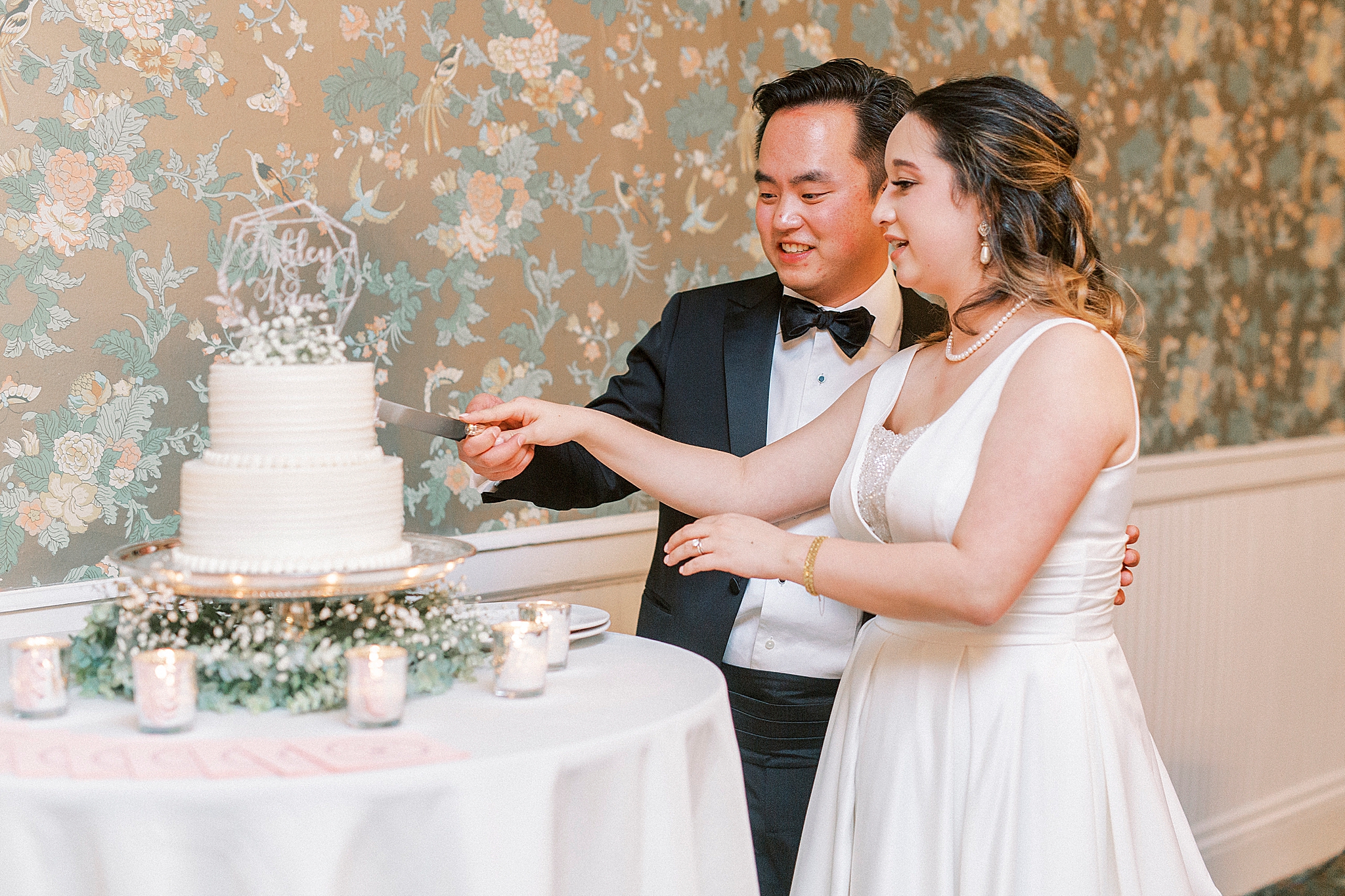 bride and groom cut wedding cake