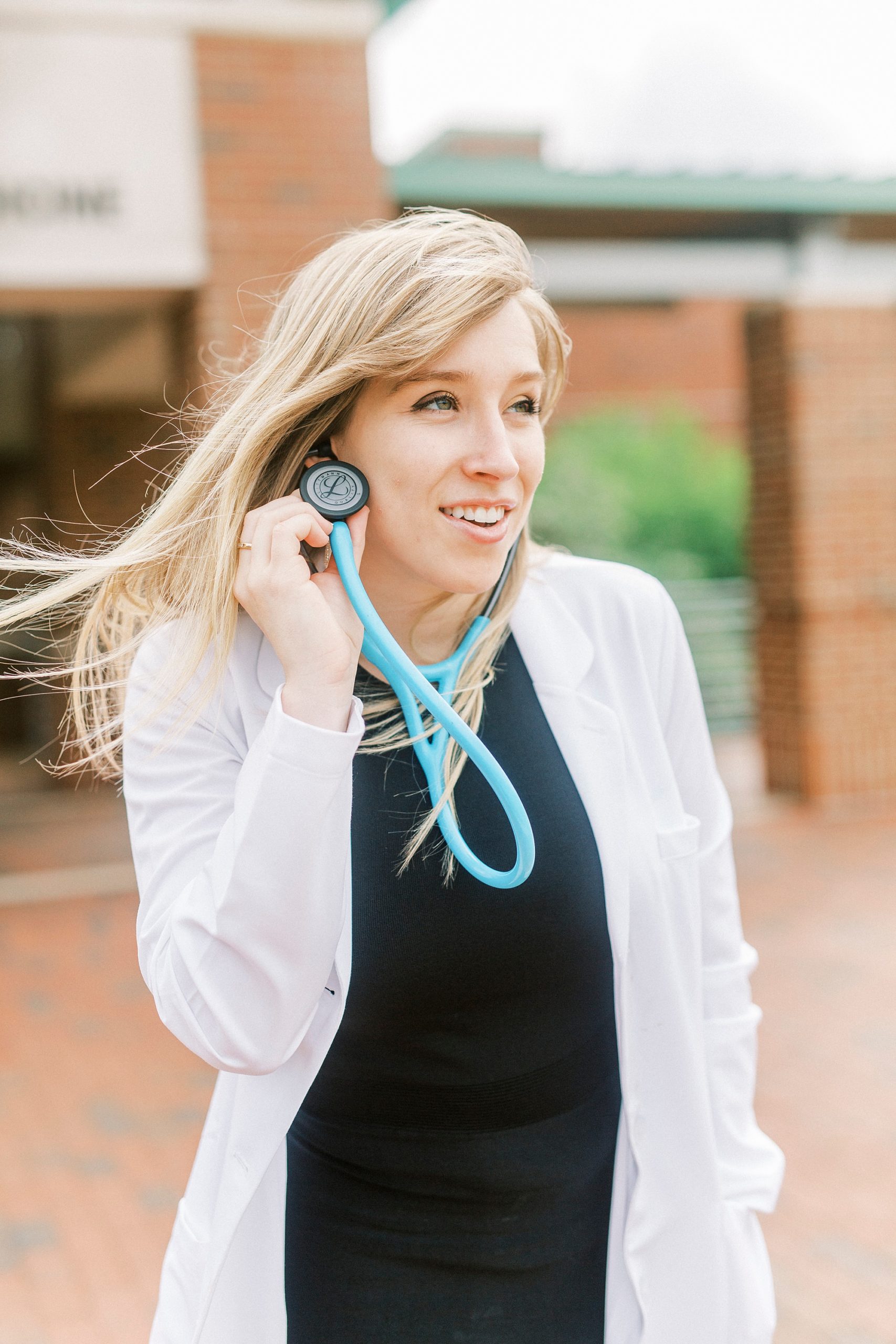 senior portraits of college grad listening to stethoscope
