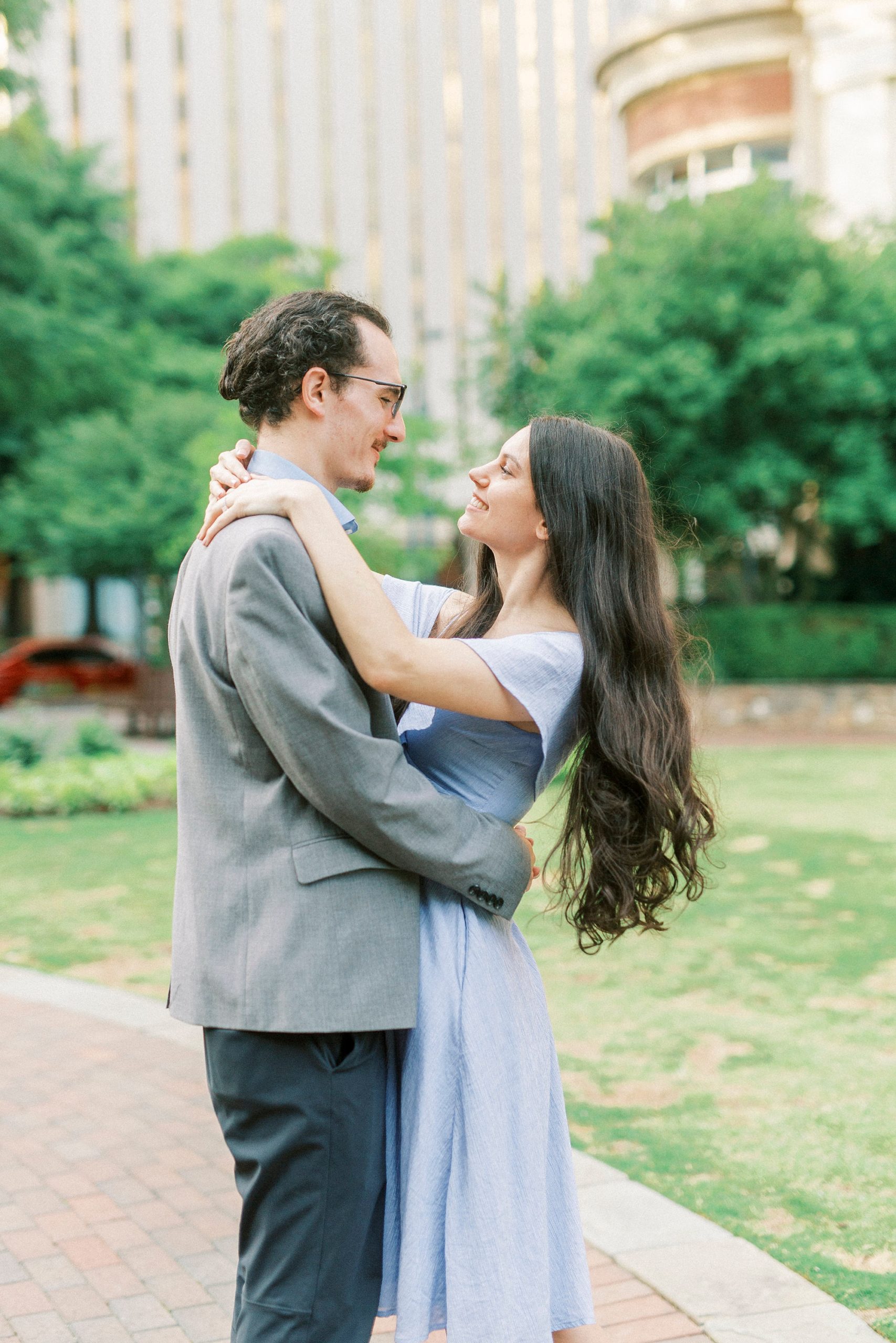 bride and groom twirl around during The Green Charlotte engagement session