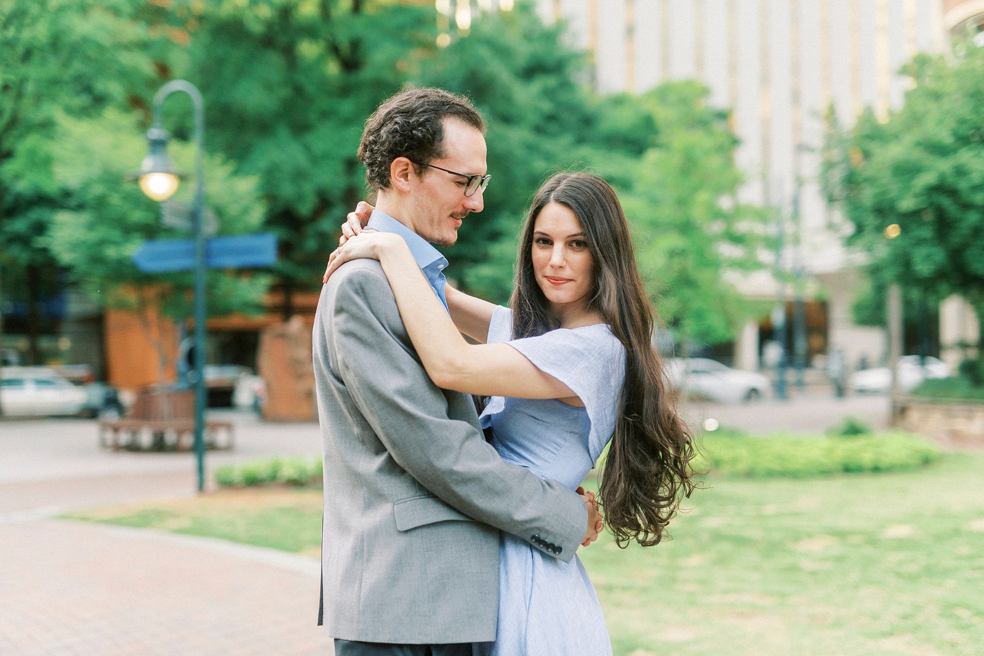 groom looks at bride who looks at the camera