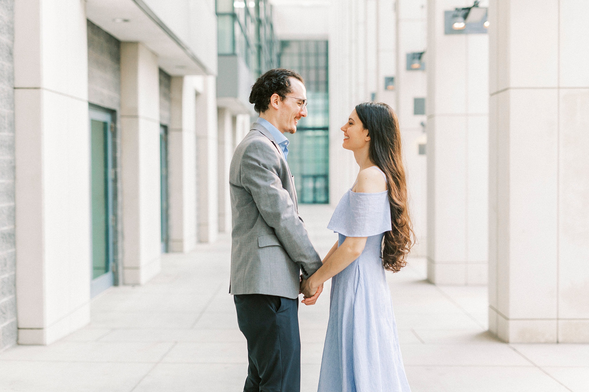 bride and groom hold hands in Charlotte NC hallway