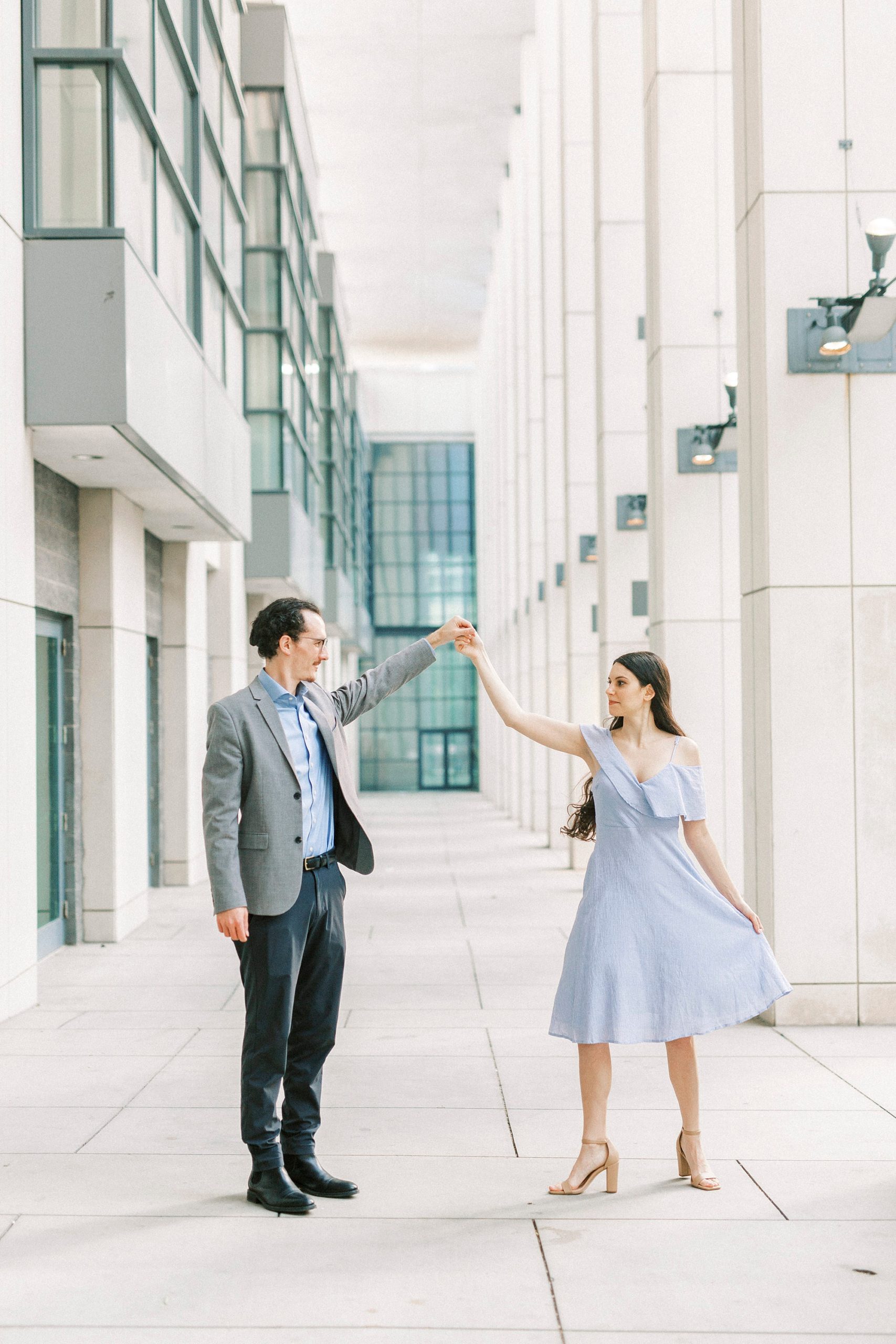 groom twirls bride during NC engagement session