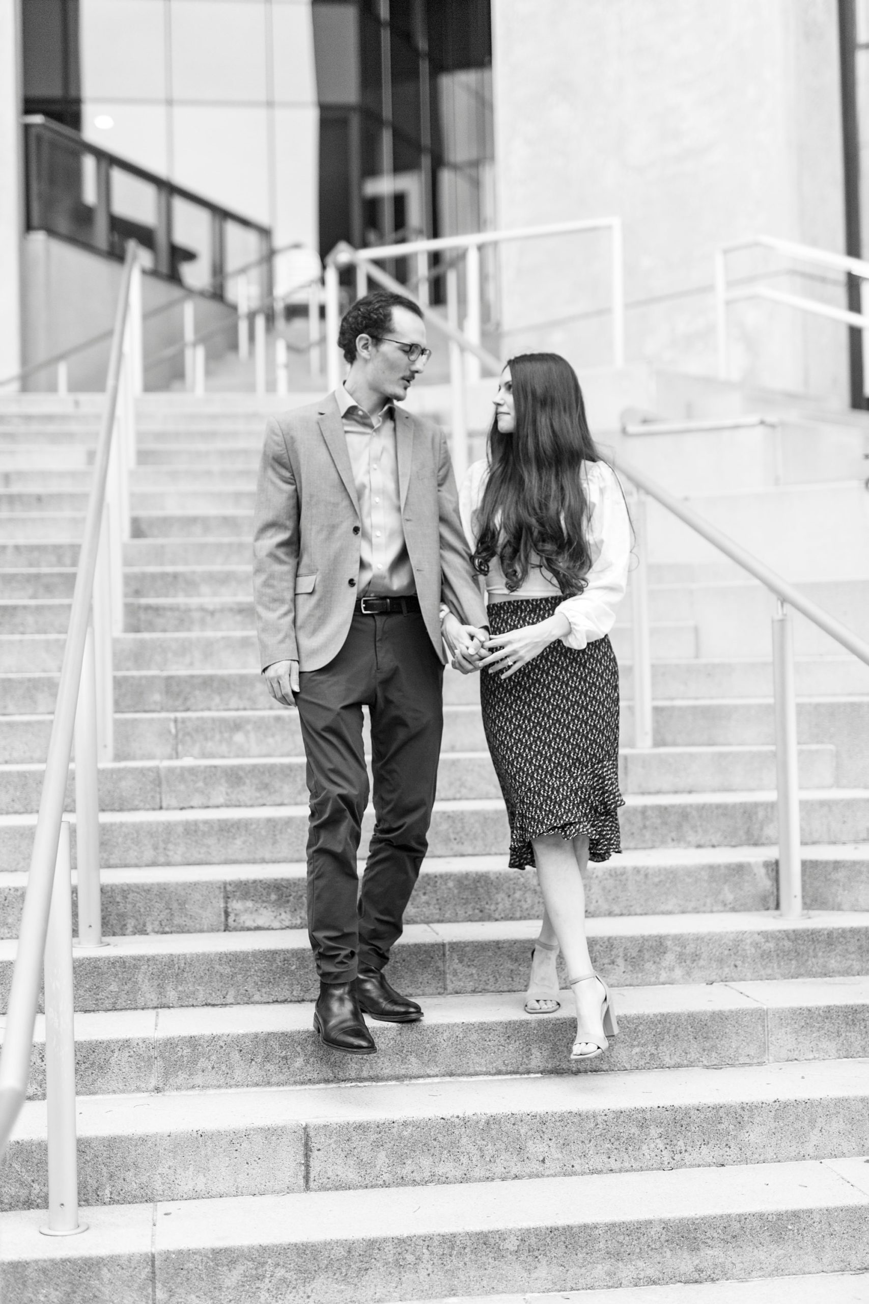 engaged couple walks down steps at The Mint Museum