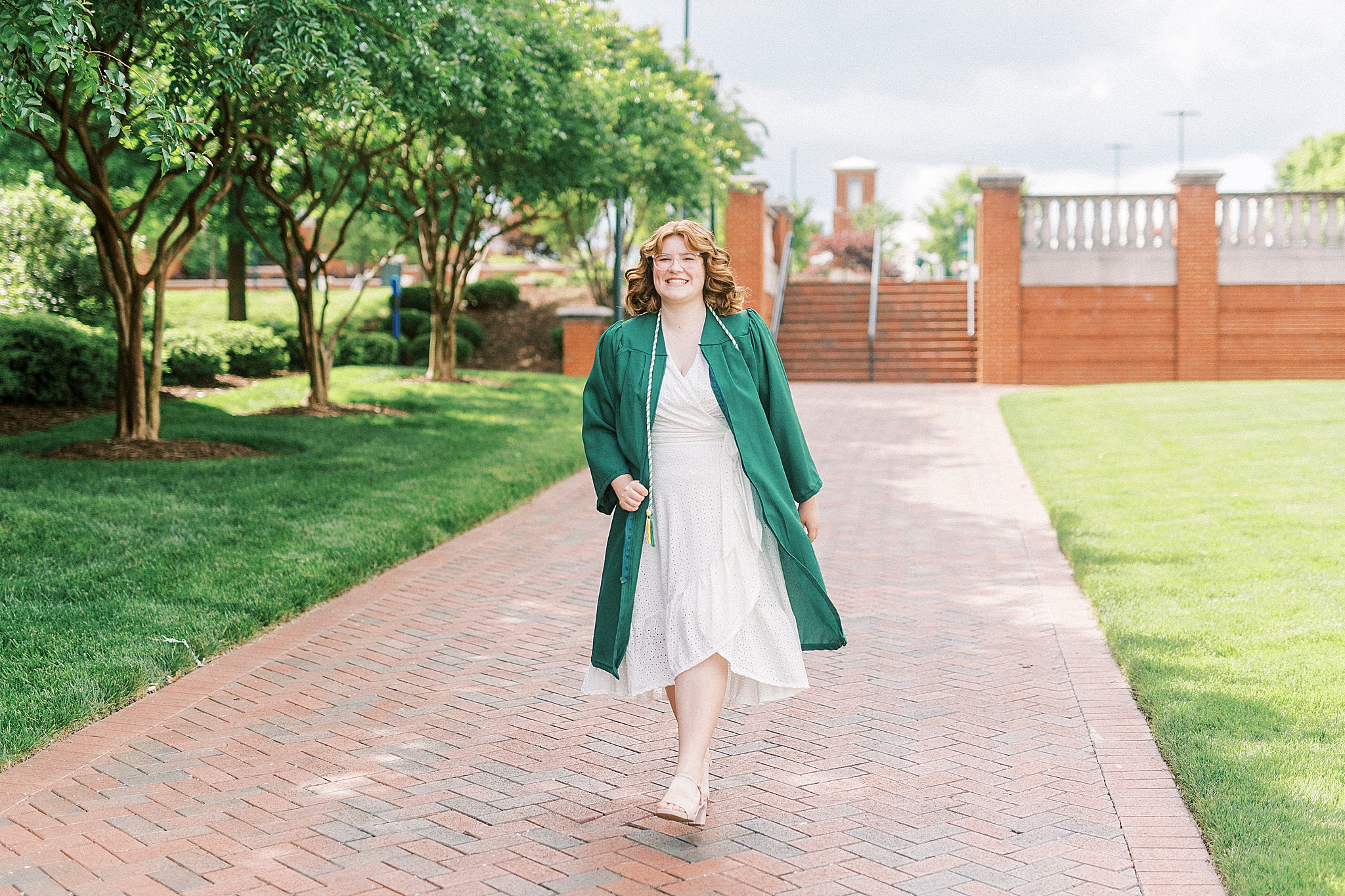 senior walks through UNCC campus during senior photos