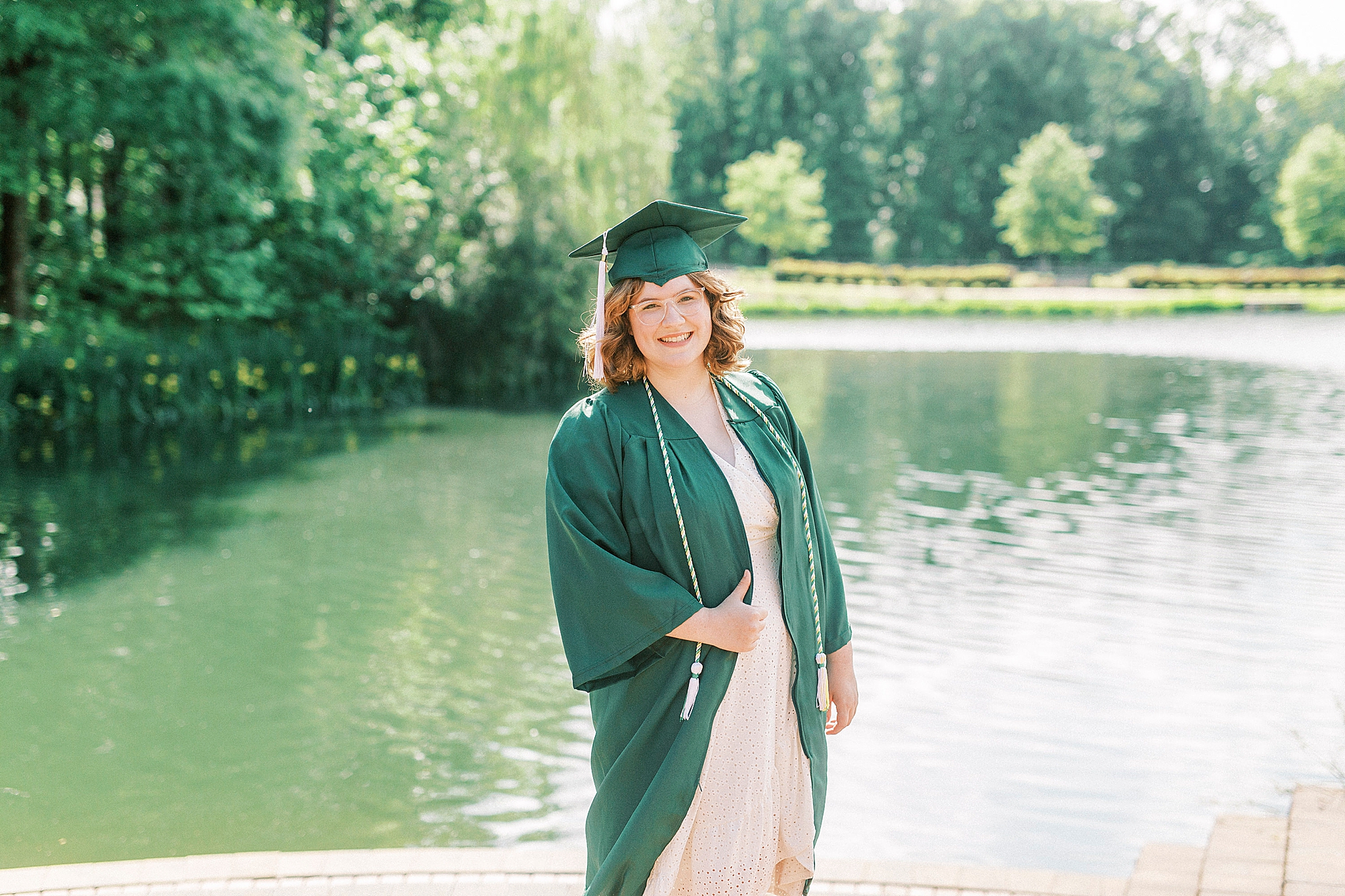 senior portrait poses by lake at UNCC