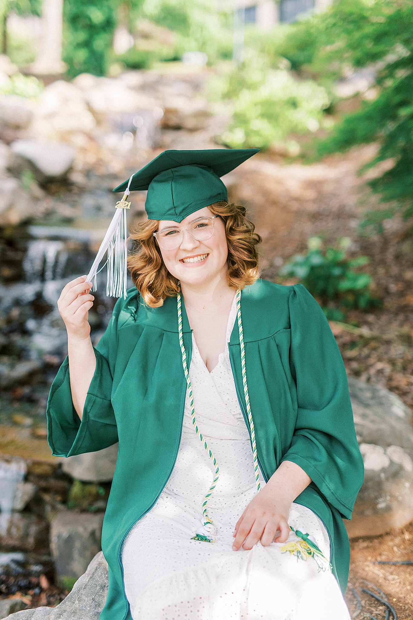 college senior holds tassel on cap at UNCC