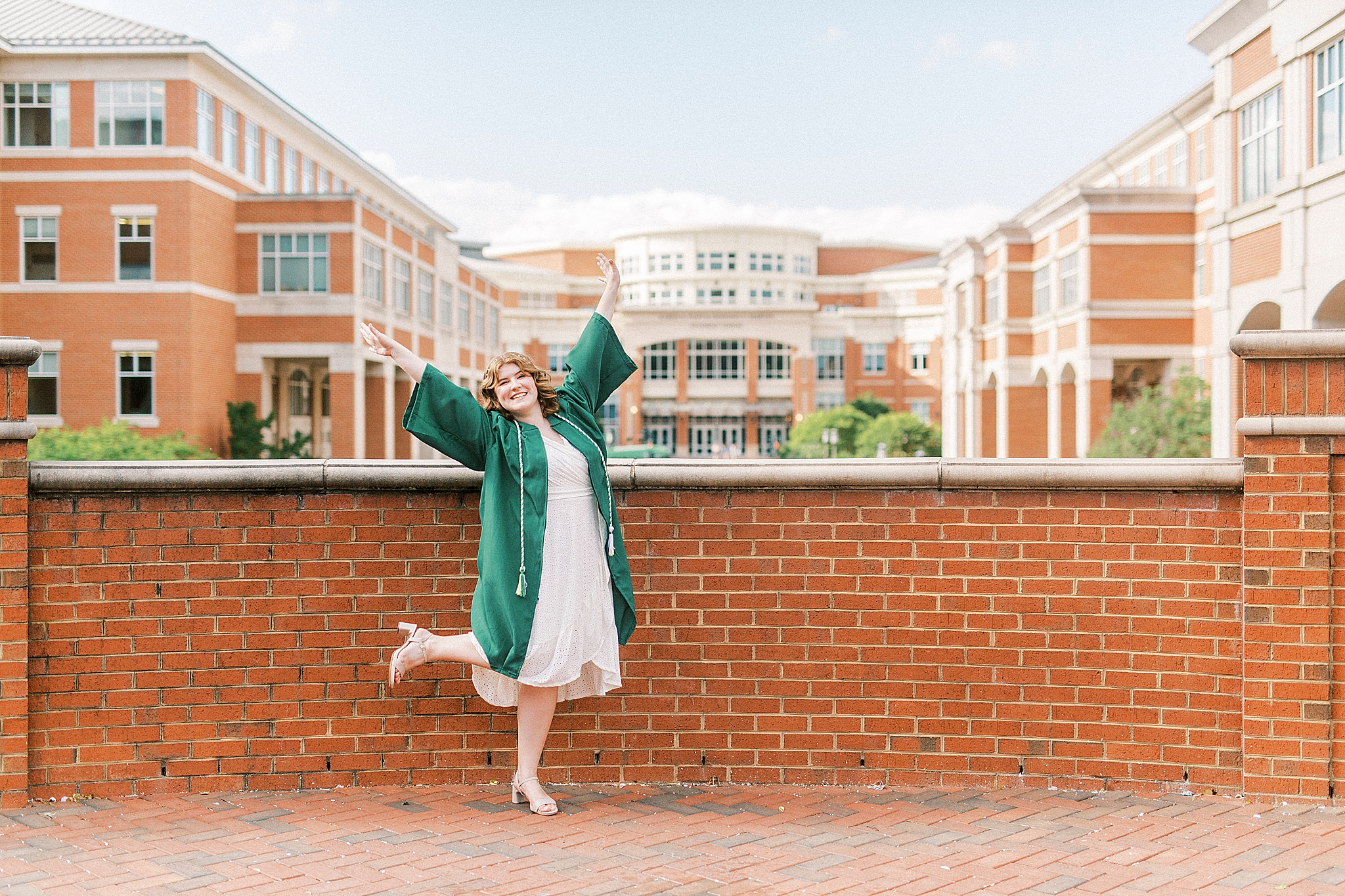 senior celebrates during UNCC senior pictures