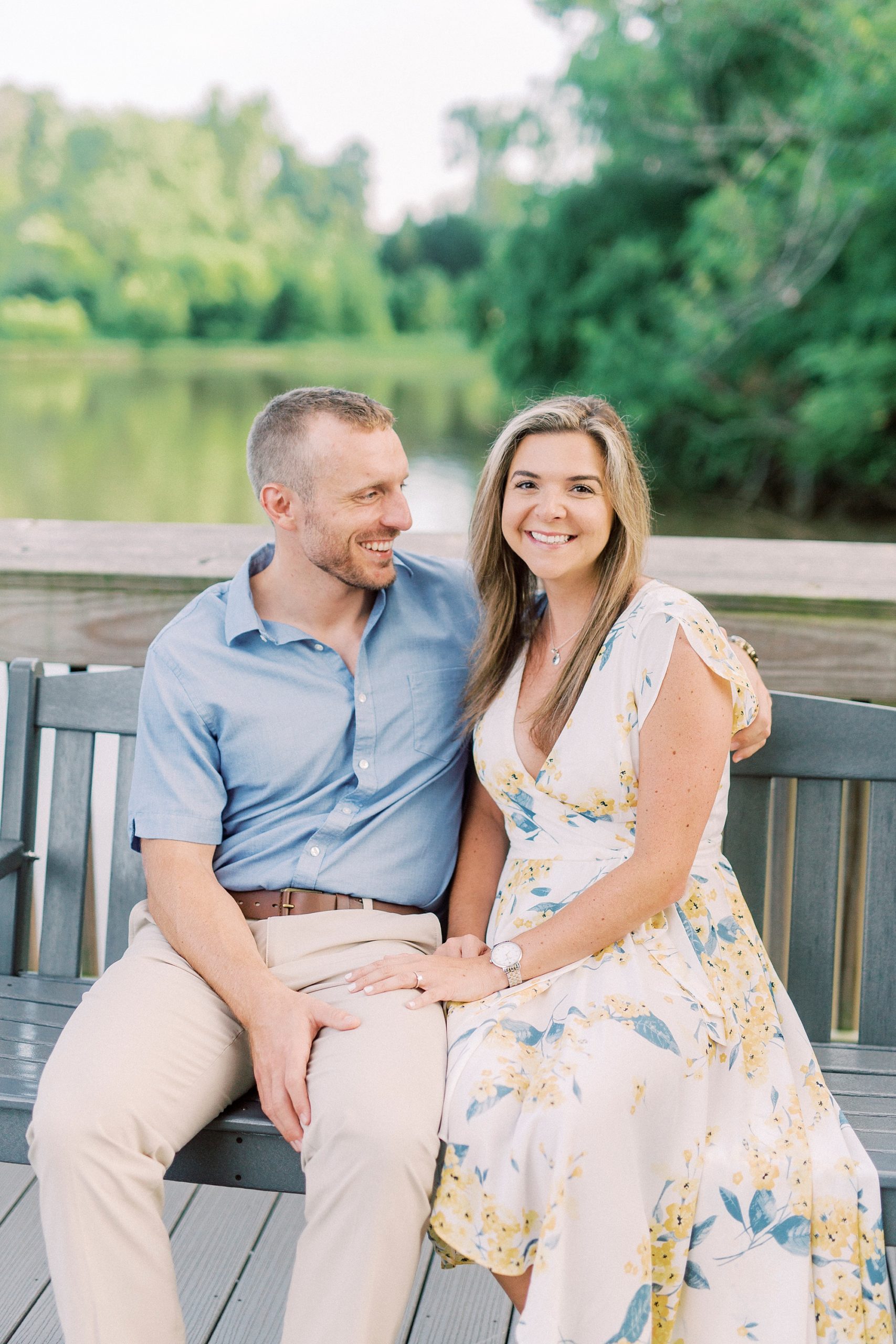 couple sits on wooden bench in local park