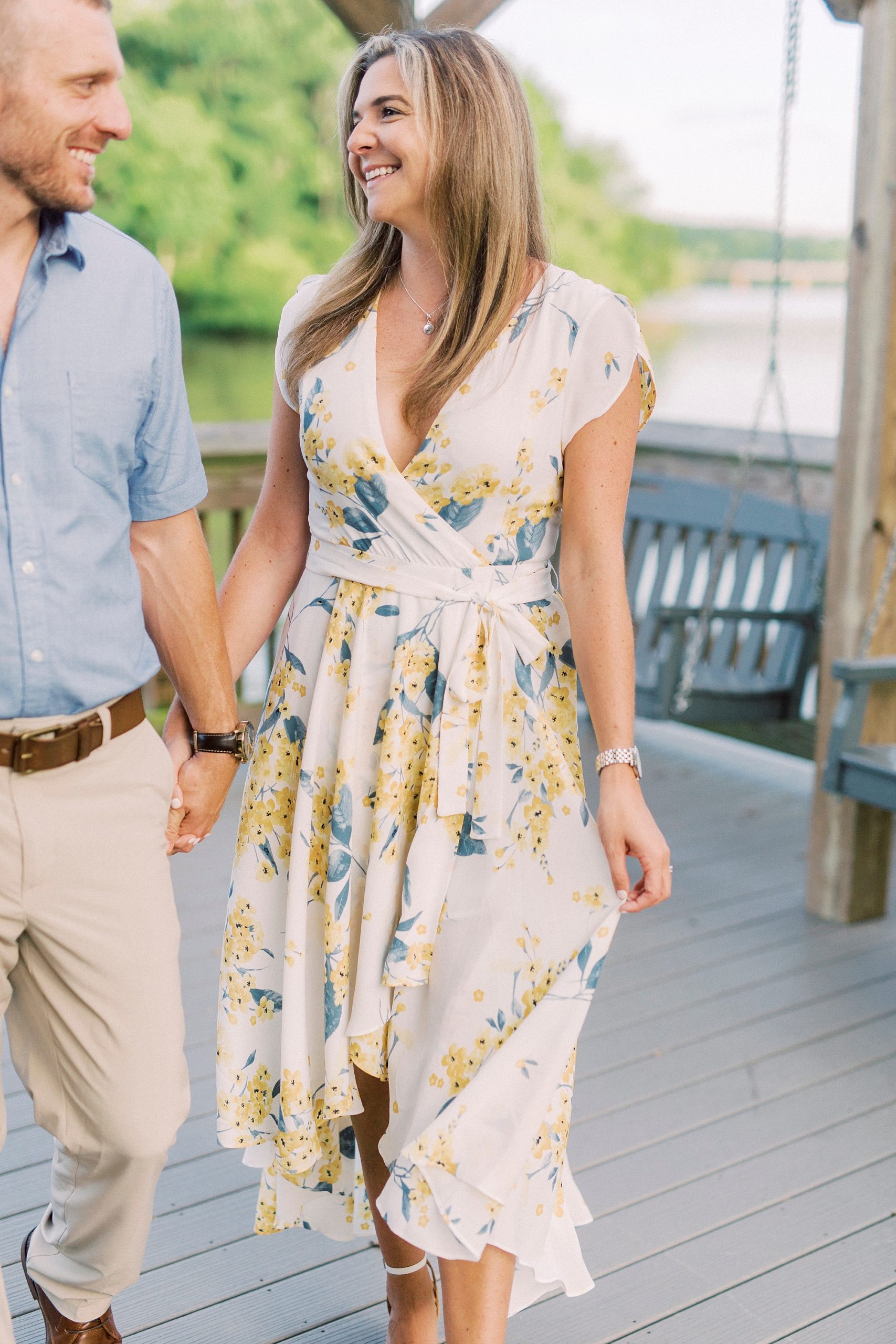 bride and groom hold hands walking through pier at Kevin Loftin Park