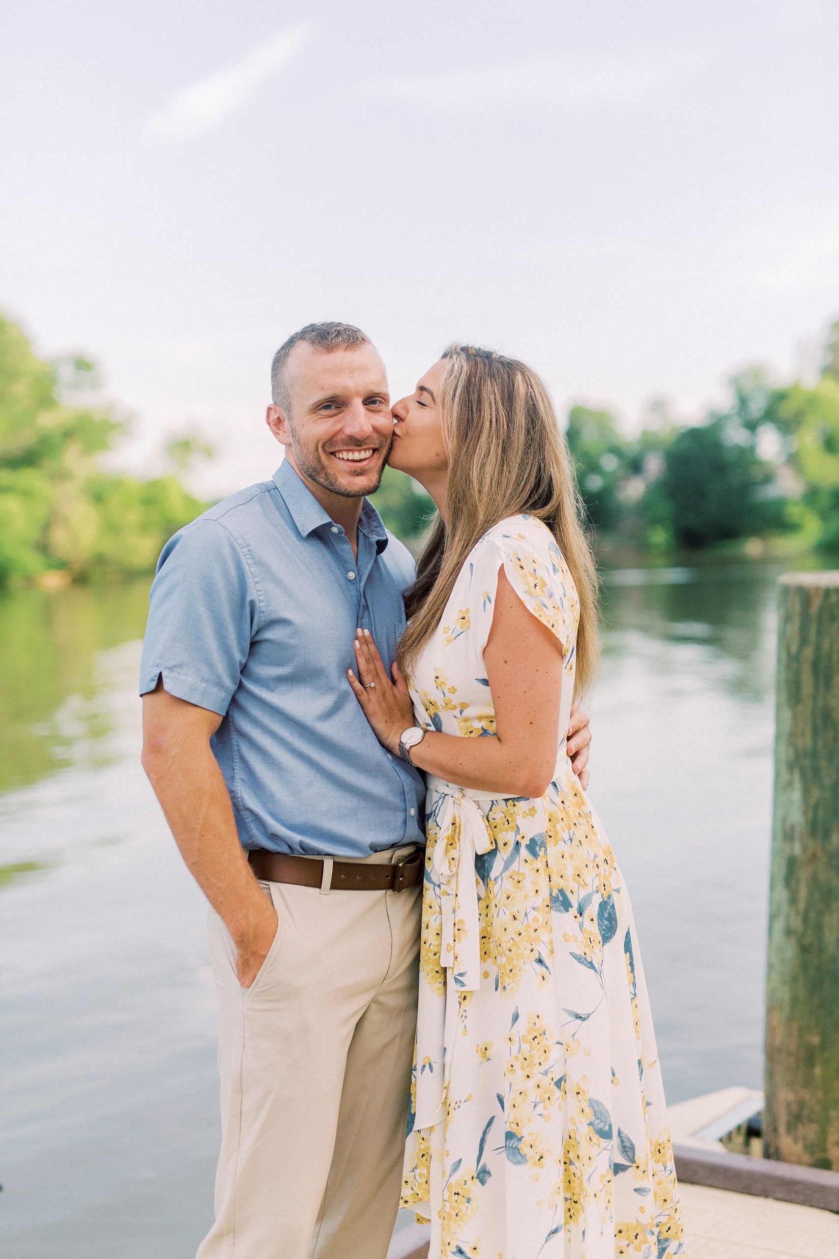 bride kisses groom's cheek during Catawba River engagement photos