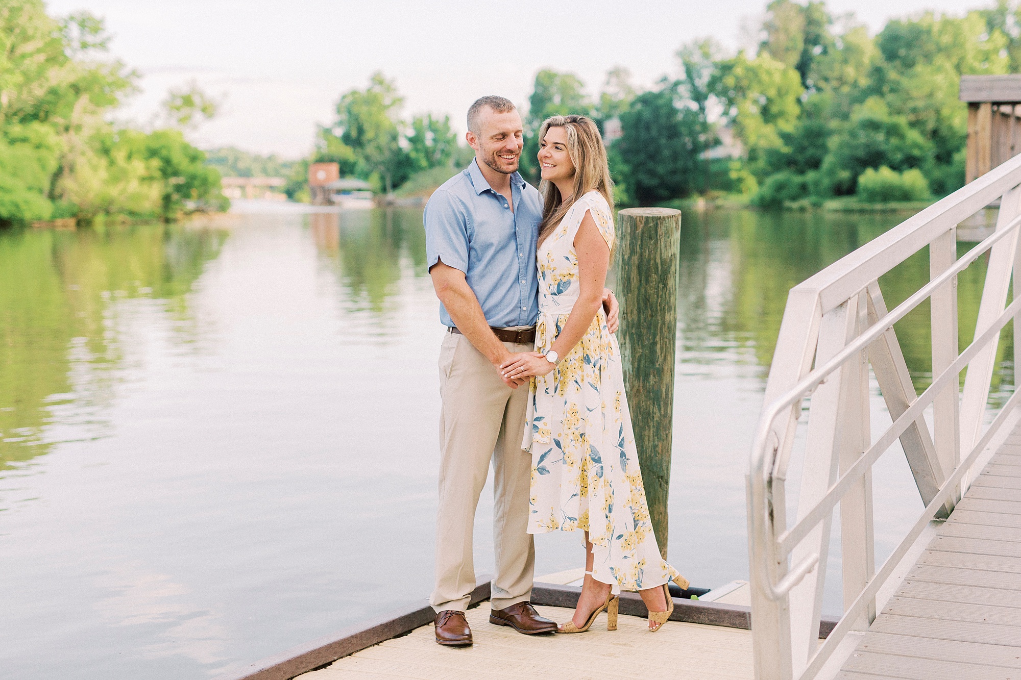 engaged couple stand on wooden pier in NC