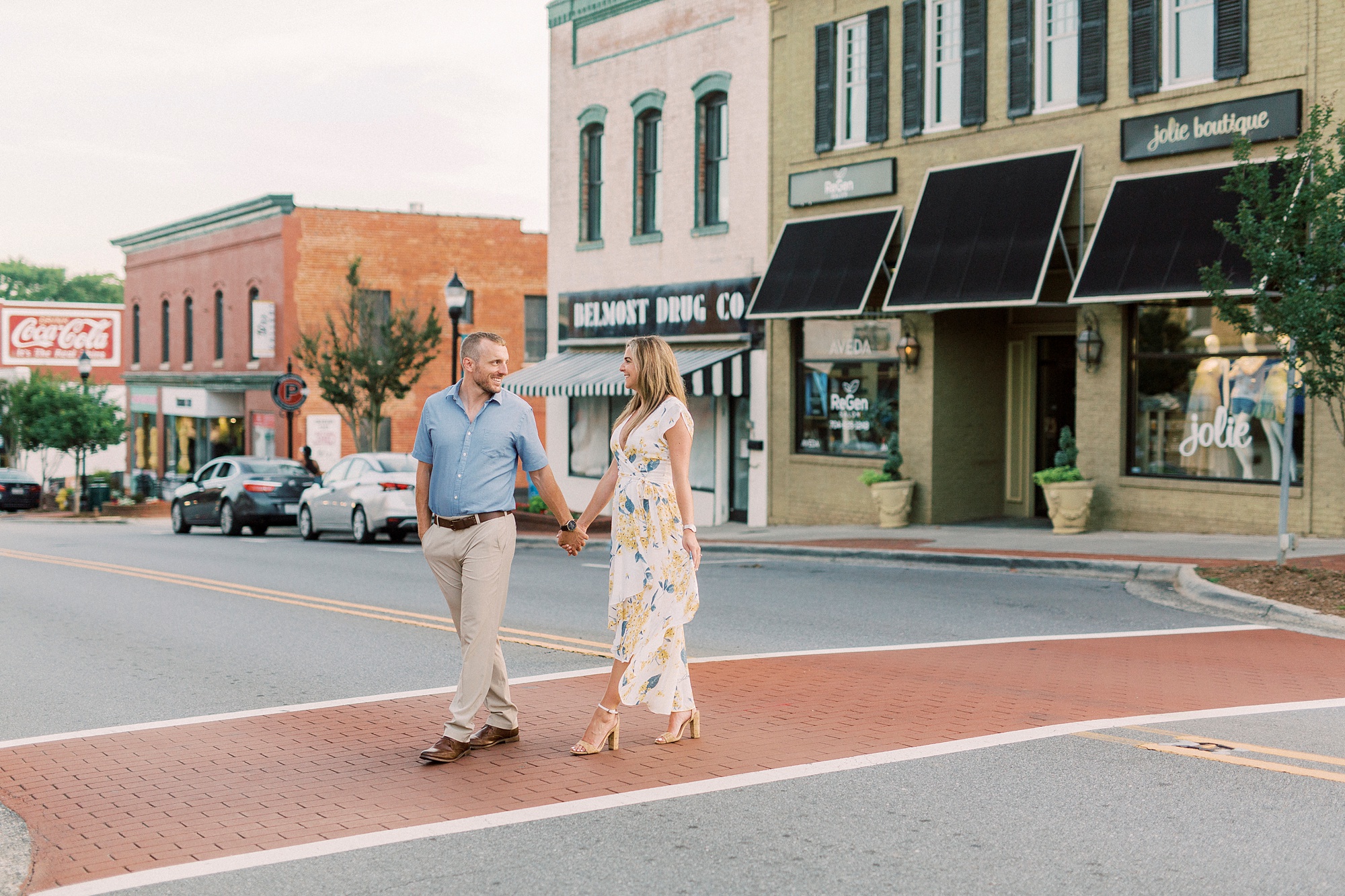 engaged couple crosses road in Downtown Belmont