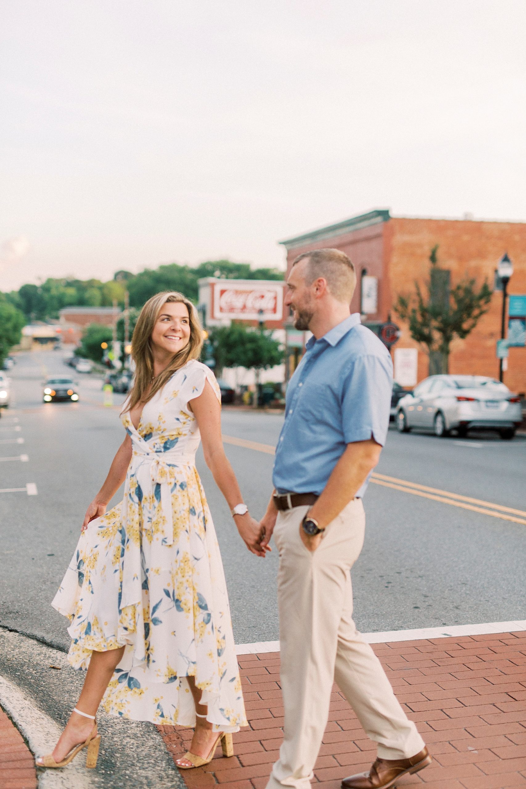 couple walks through crosswalk in Downtown Belmont