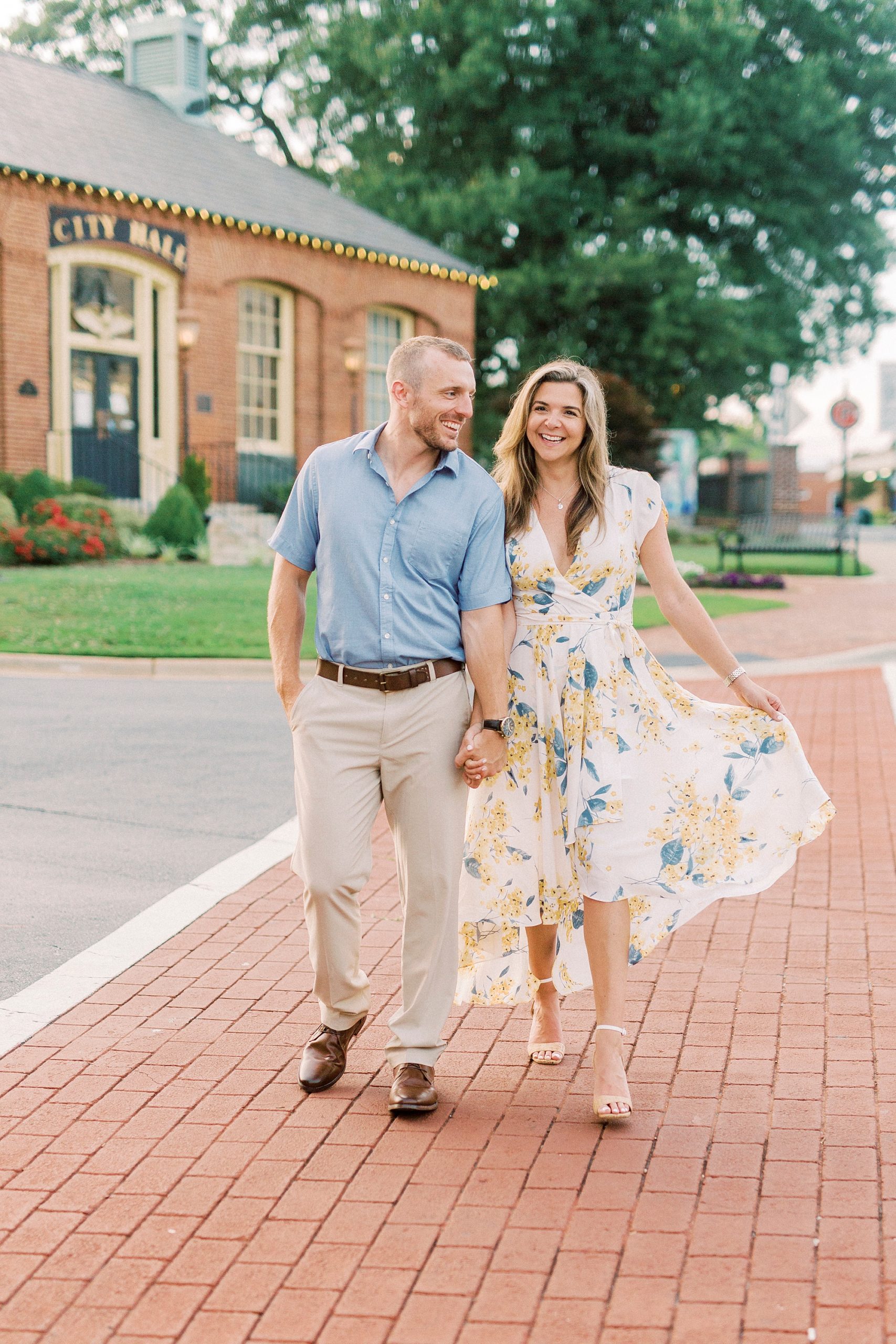 engaged couple walks through crosswalk in Downtown Belmont