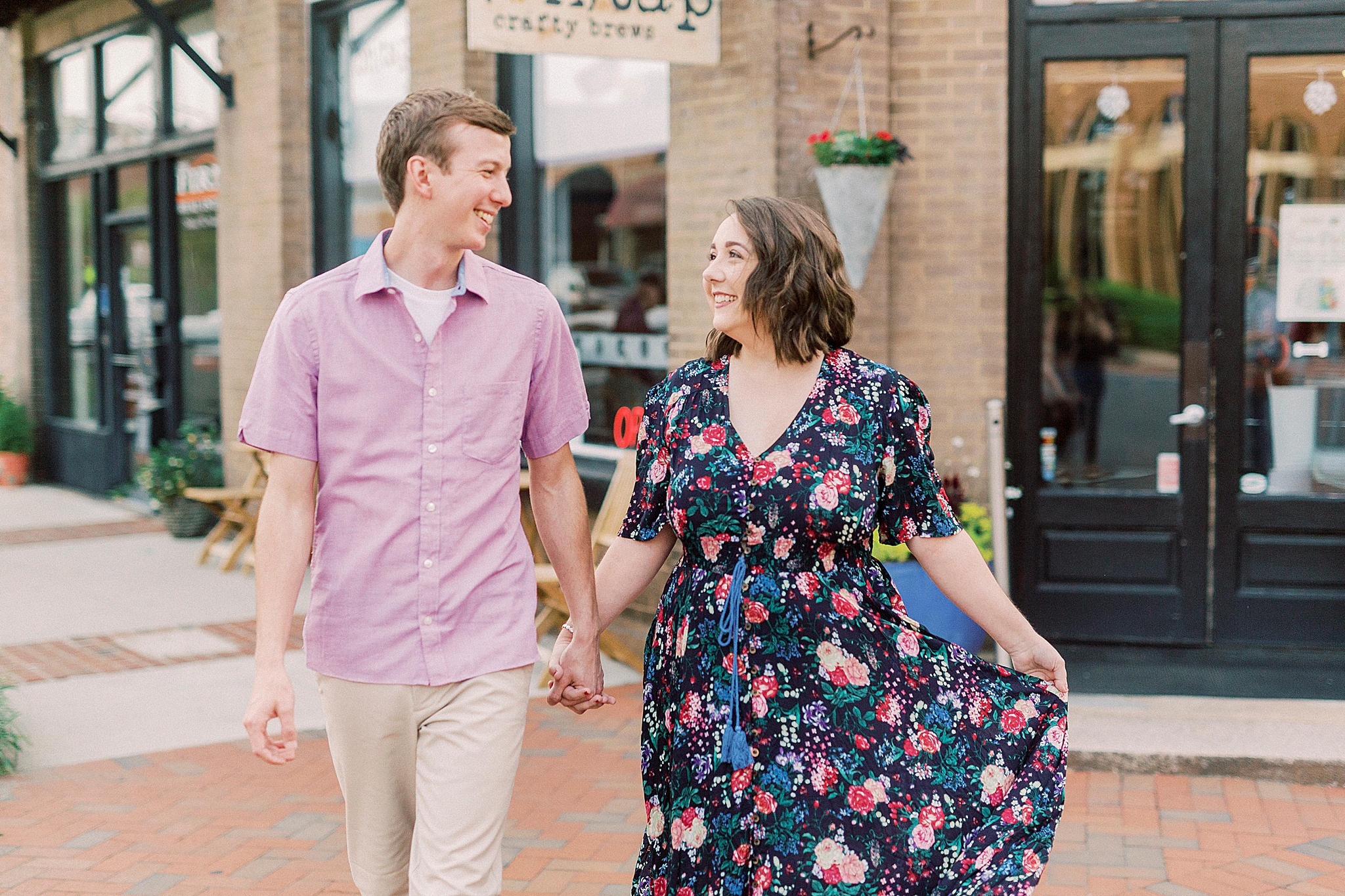 married couple walks down sidewalk in Downtown Mooresville