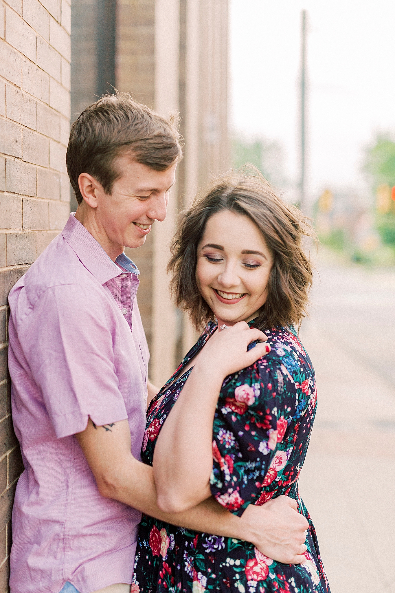 wife looks over shoulder during Downtown Mooresville portraits