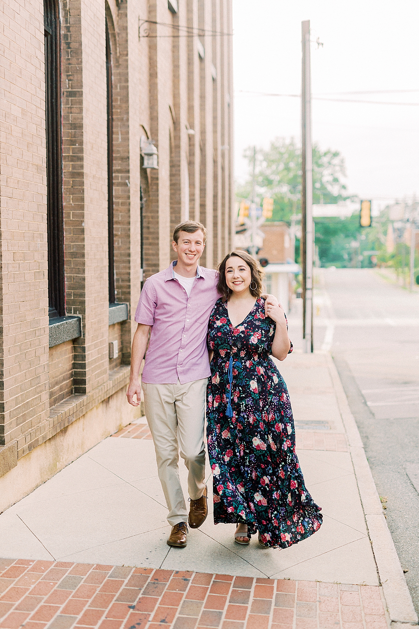 couple walks down sidewalk in Downtown Mooresville