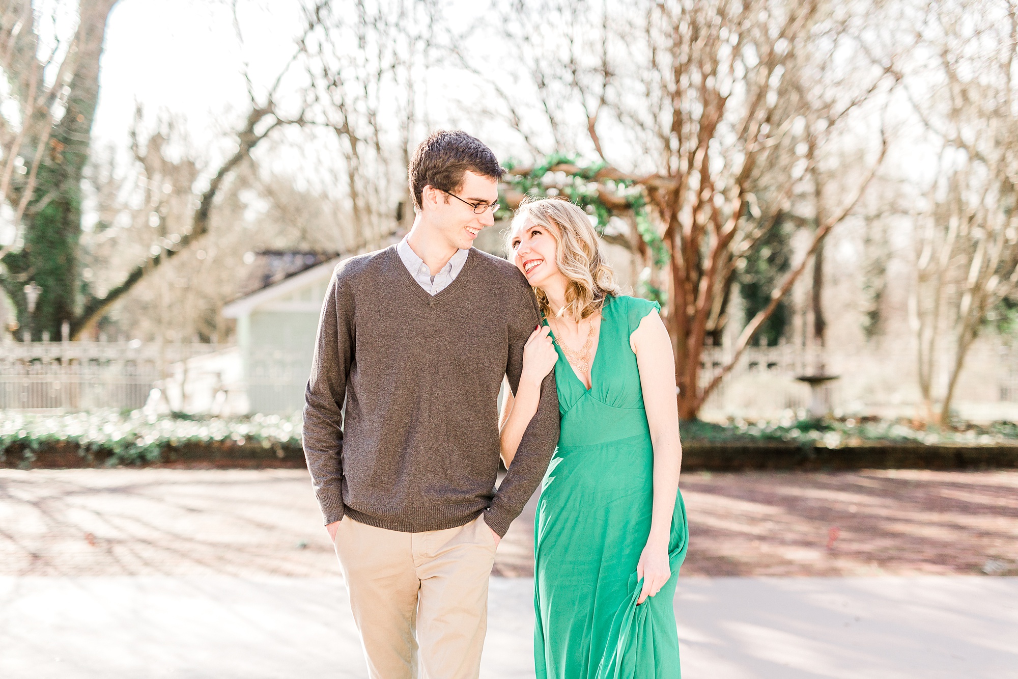 bride leans head on groom's shoulder during engagement photos at 1812 Hitching Post