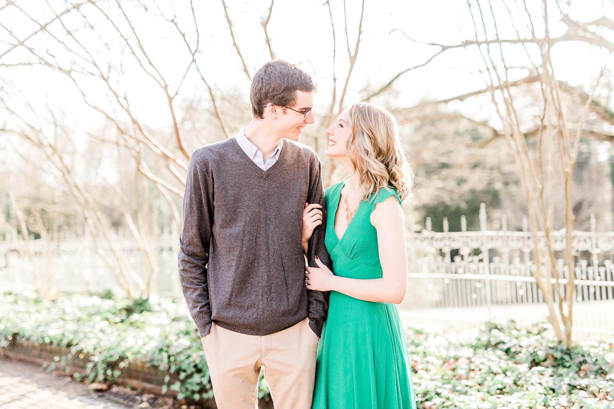 bride in green gown looks at groom