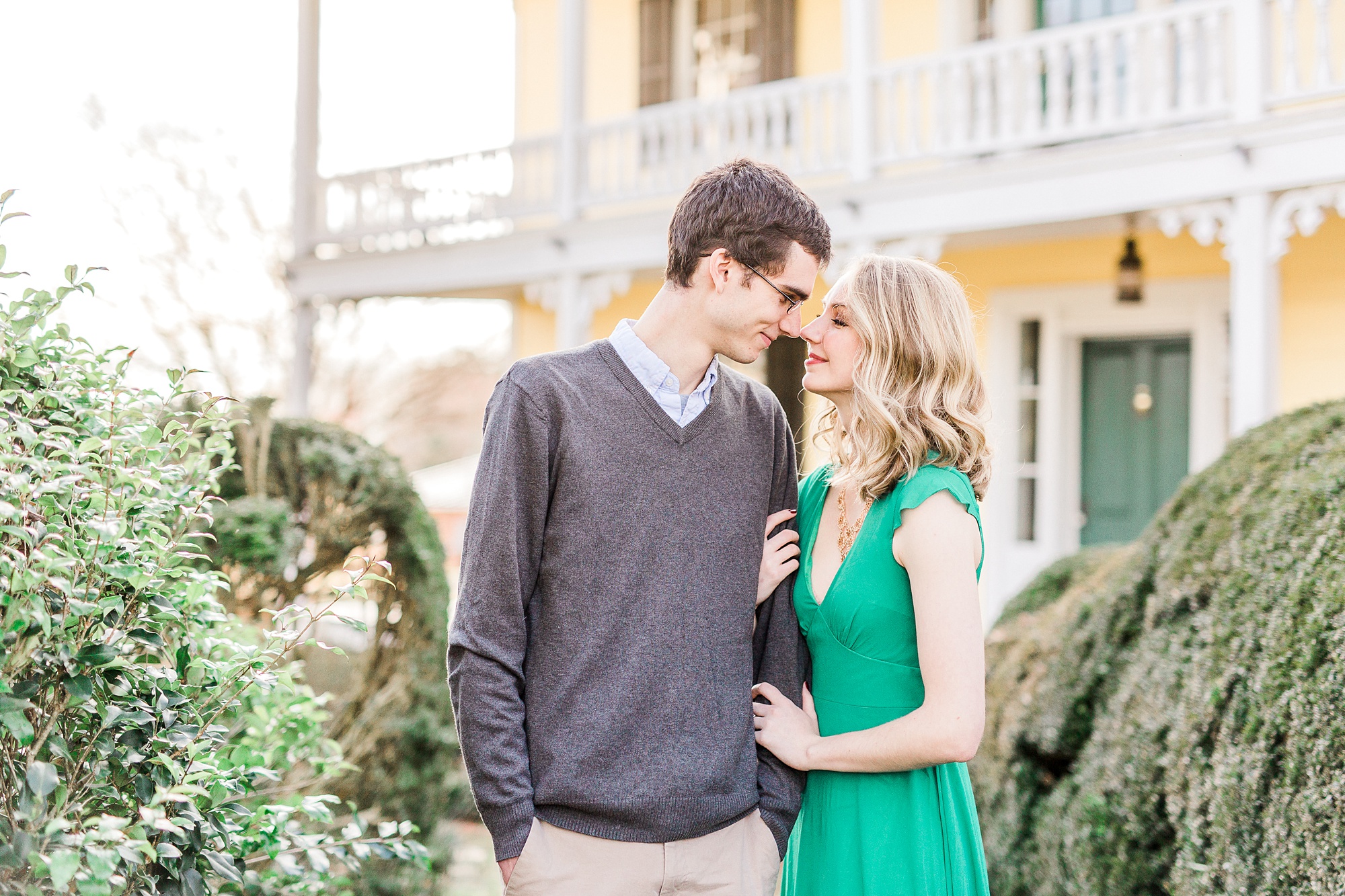 bride and groom stand with noses touching during 1812 Hitching Post engagement session