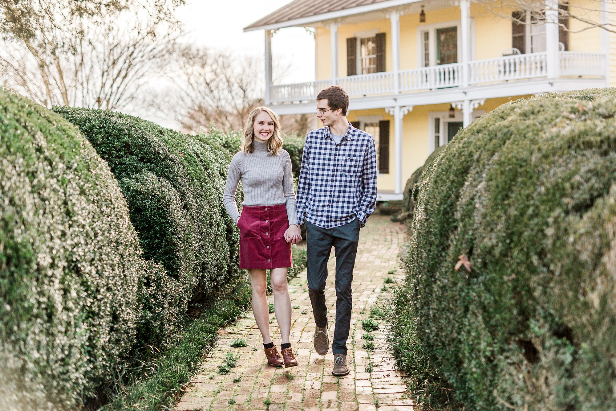 bride and groom hold hands walking down pathway at the 1812 Hitching Post