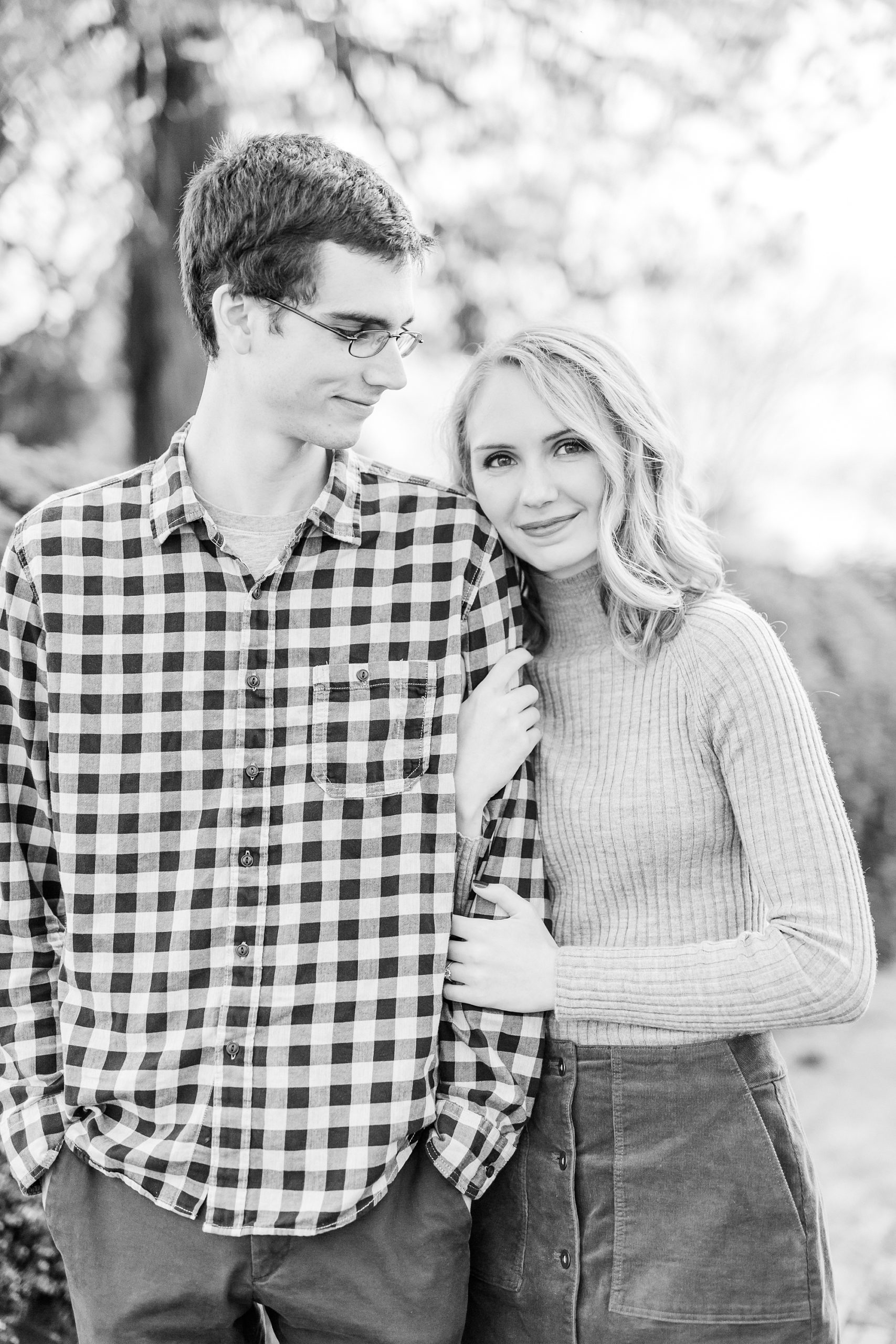 bride leans on groom's arm during NC engagement session