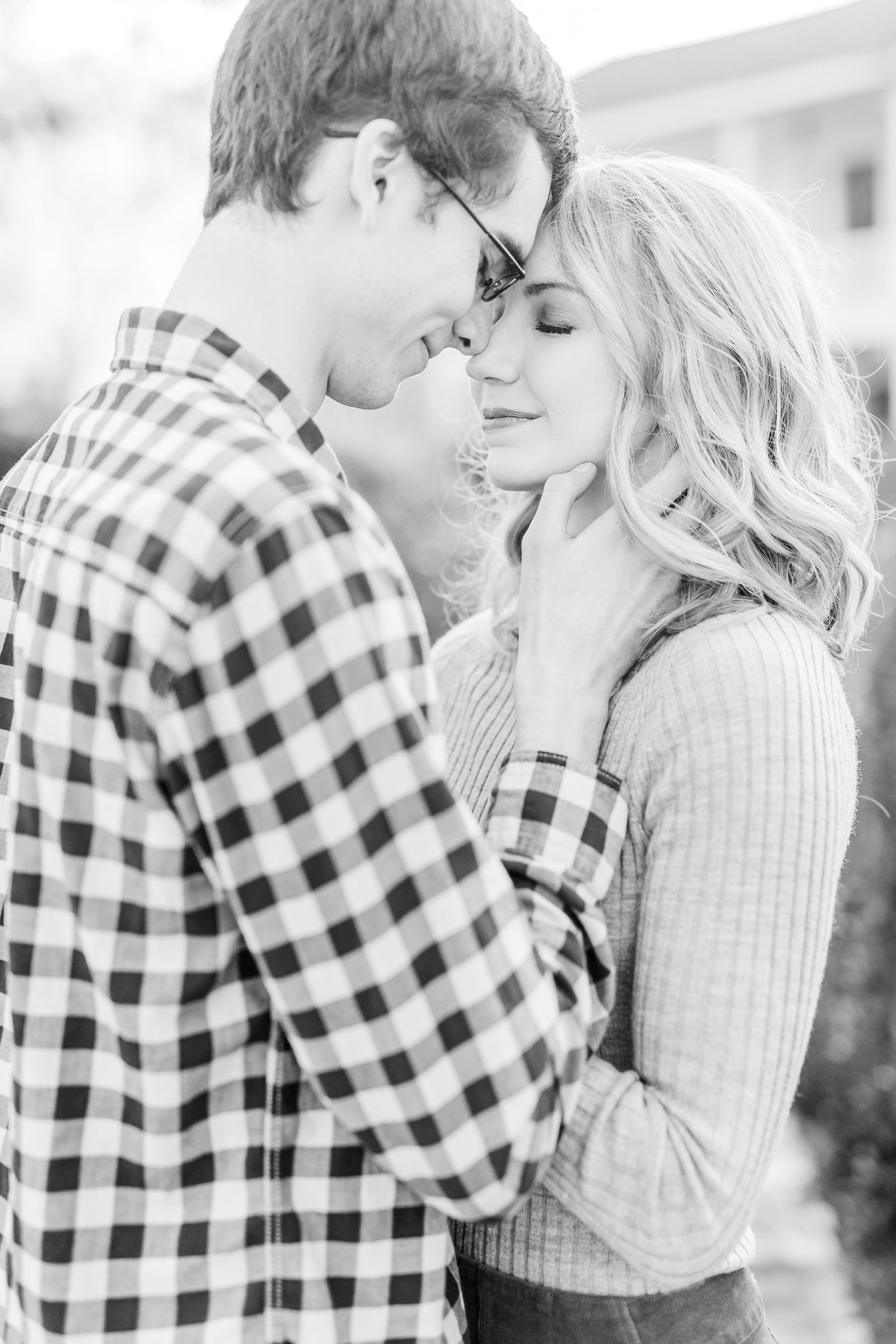 groom holds bride's chin while he touches foreheads with her at the 1812 Hitching Post