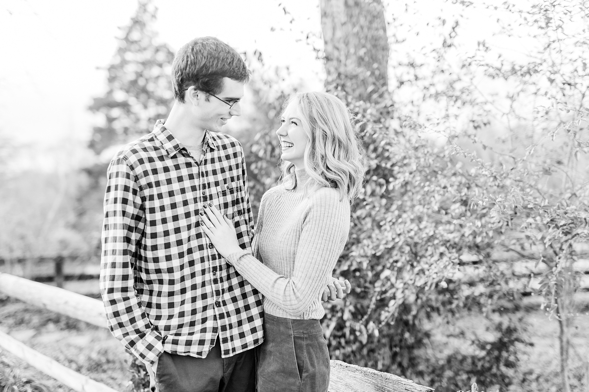engaged couple stands together on path at 1812 Hitching Post